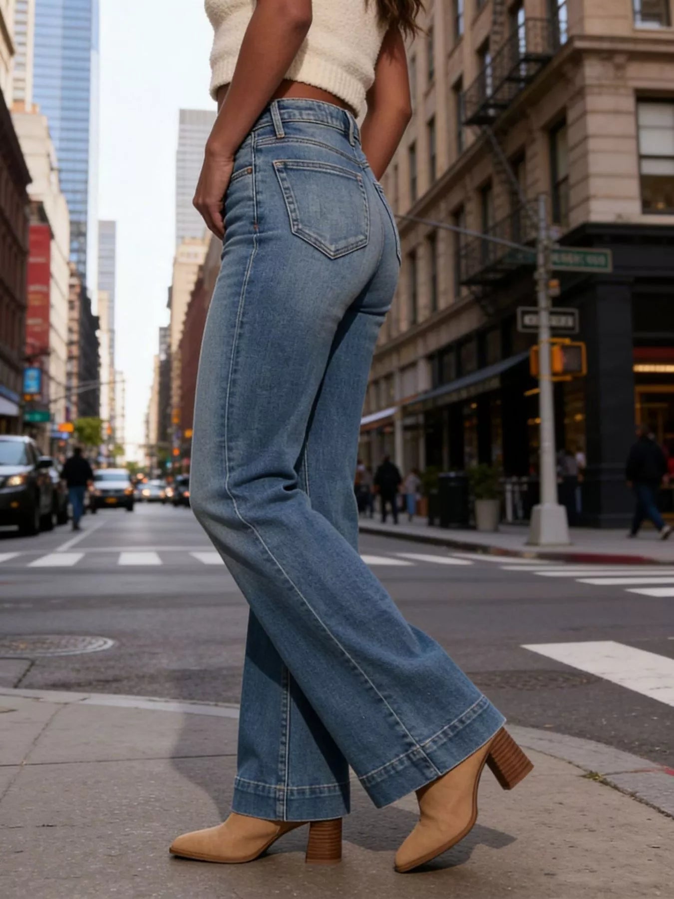 High-waisted flare leg denim jeans by Trendsi, showcased on a model with a fitted waist and wide leg silhouette.