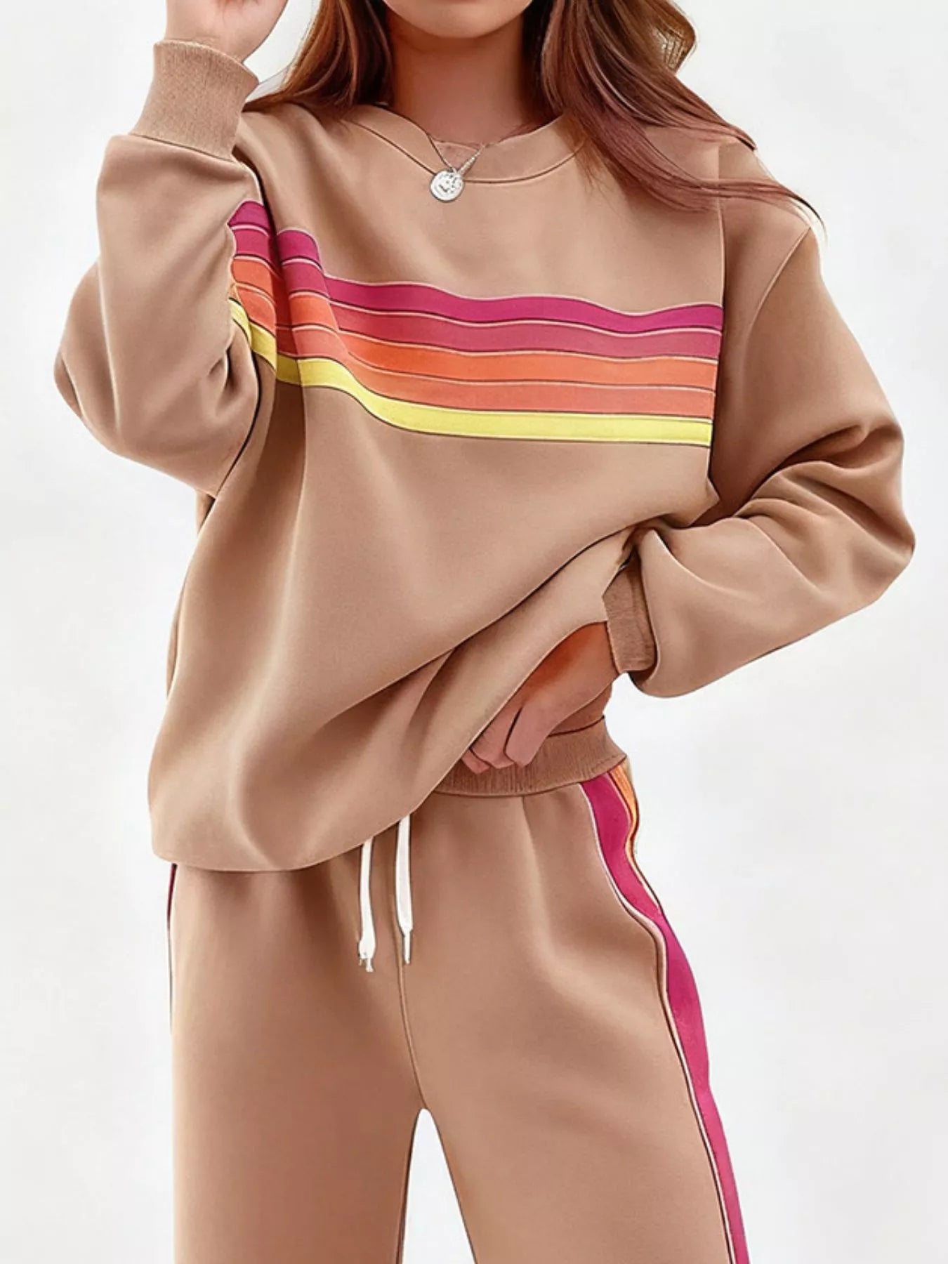 Striped round neck sweatshirt and matching pants set by Trendsi, casual loungewear with bold stripe pattern and comfortable fit.