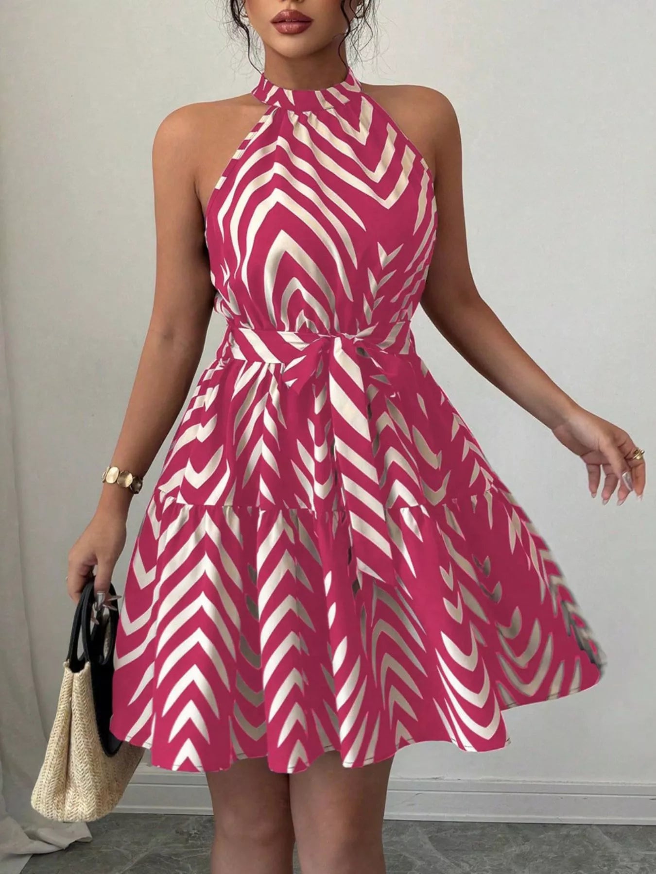 Zebra print halter neck dress with tie waist and ruffle hem, trendy dress by Trendsi, shown on a model.