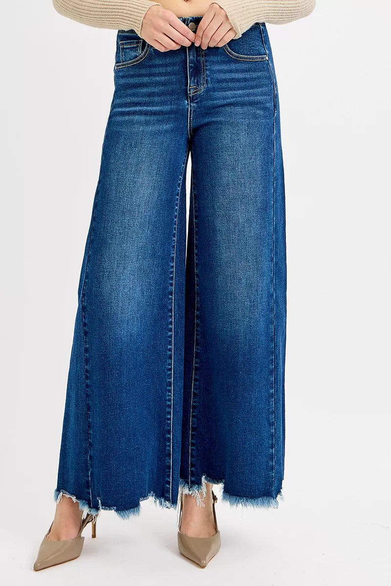 Frayed hem high rise ankle wide denim jeans by Trendsi, showcasing a relaxed fit and distressed frayed hem detail.
