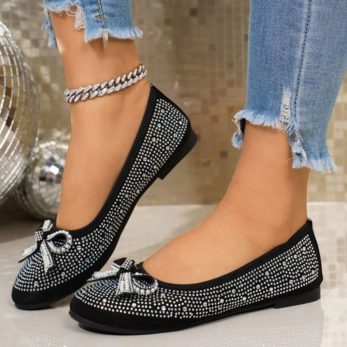 Close-up of trendy rhinestone bow accent slip-on shoes by Trendsi, showcasing sparkling rhinestones and sleek design.