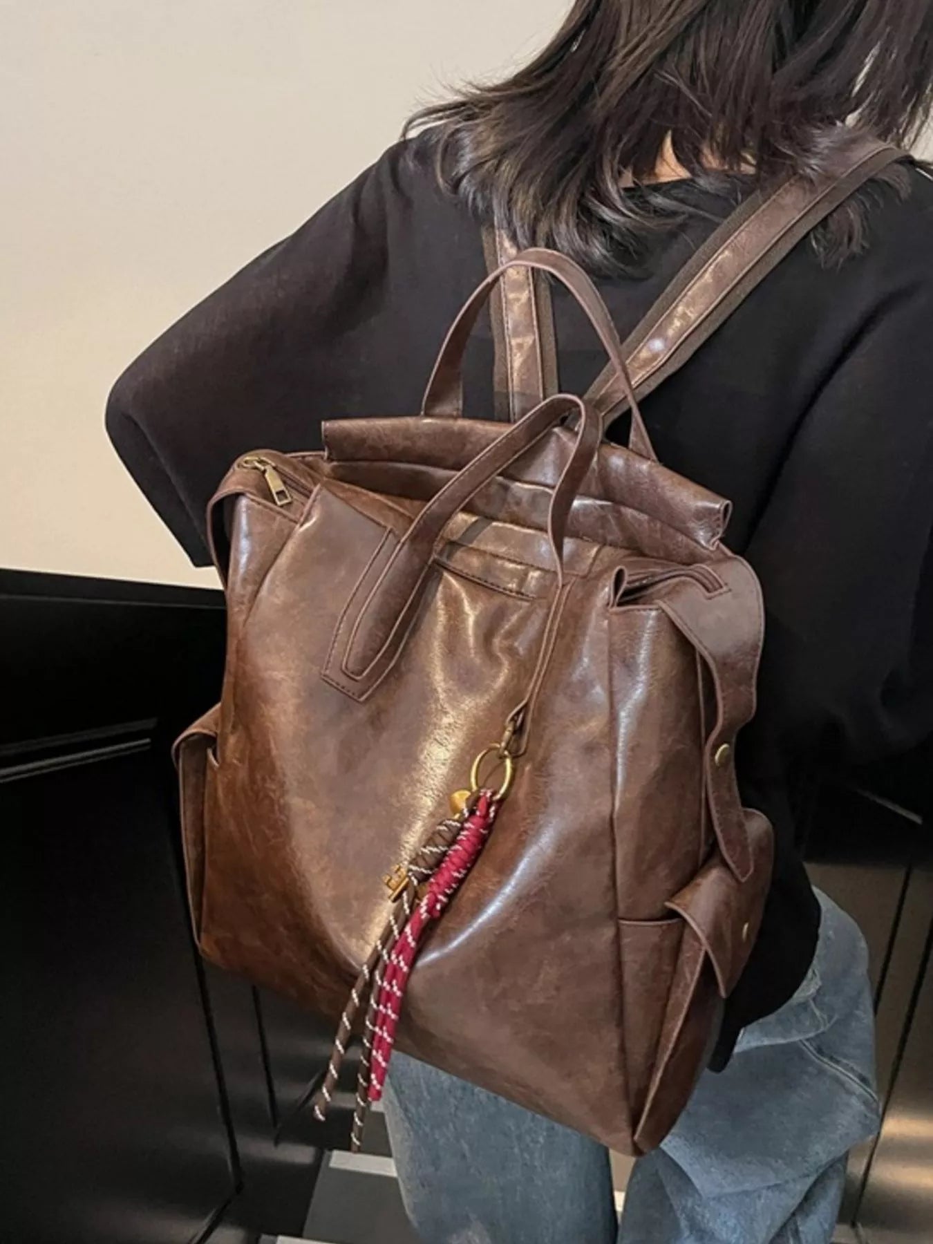 Vintage leather convertible backpack bag by Trendsi, showing a stylish brown leather backpack with adjustable straps and multiple compartments.