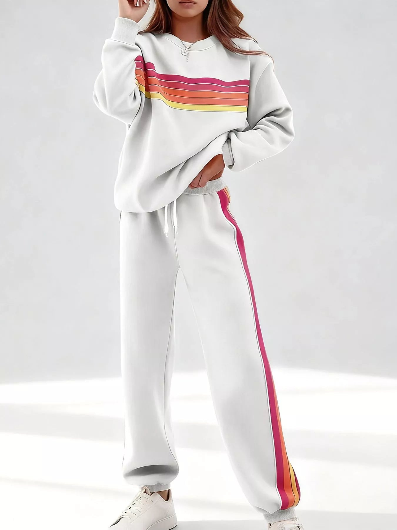 Striped round neck sweatshirt and pants set by Trendsi, featuring casual comfort and a stylish striped design for everyday wear.