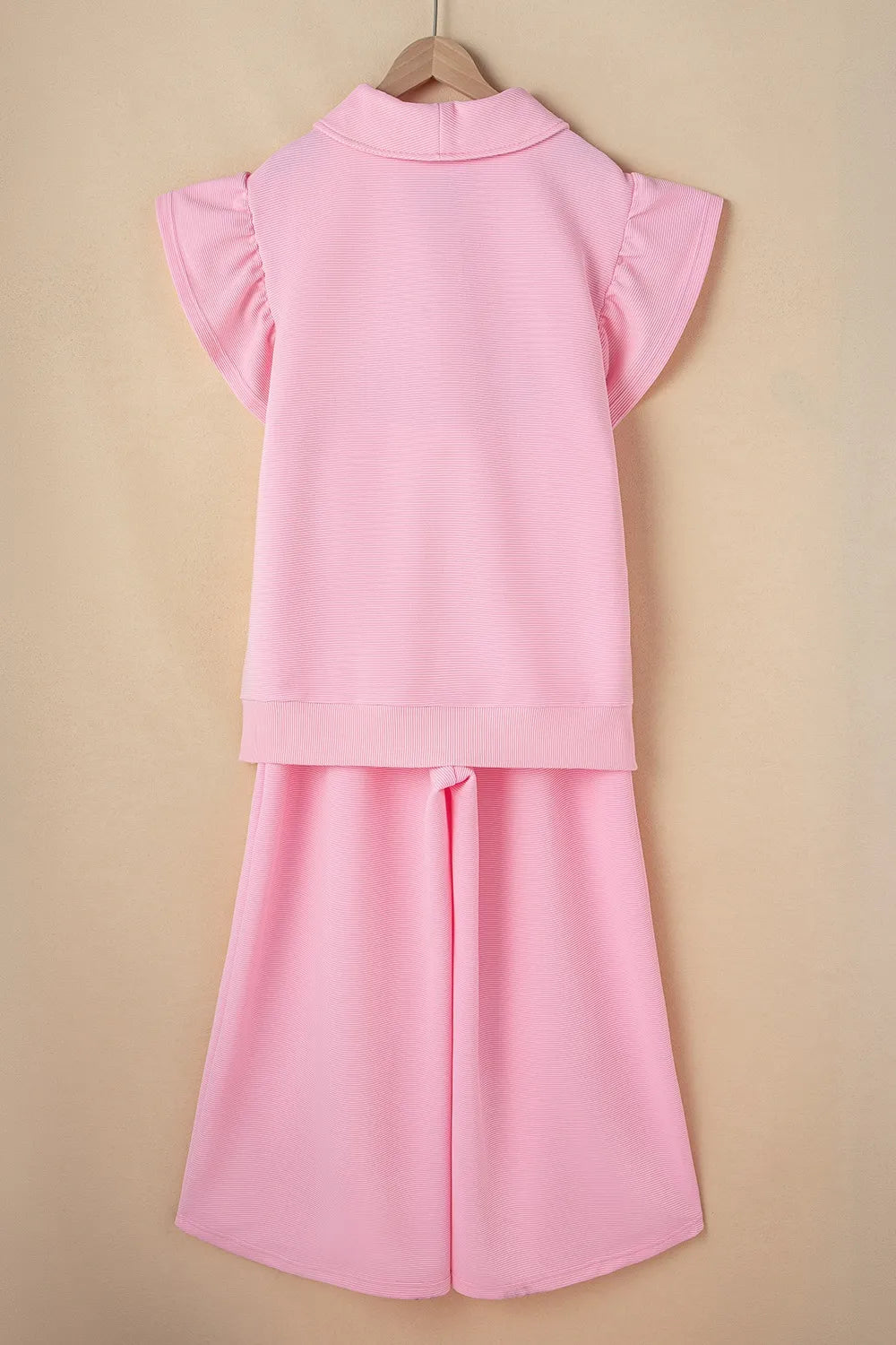 Textured ruffled sleeve zipped top and wide leg pants set from Trendsi, with stylish details and coordinated fit.