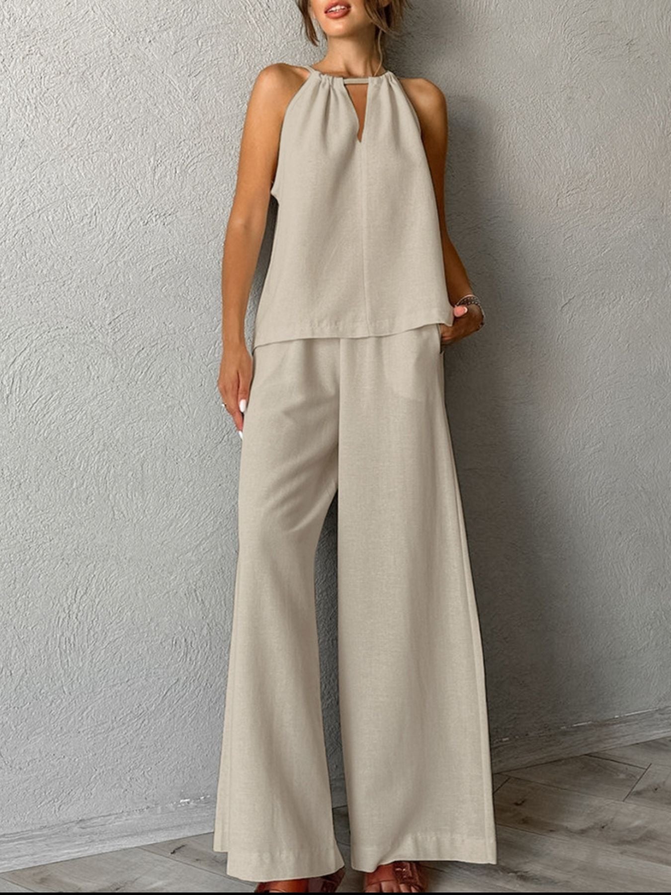 Trendsi cutout tank top and wide-leg pants set, featuring a sleeveless crop top with cutout details and flowy high-waisted pants.