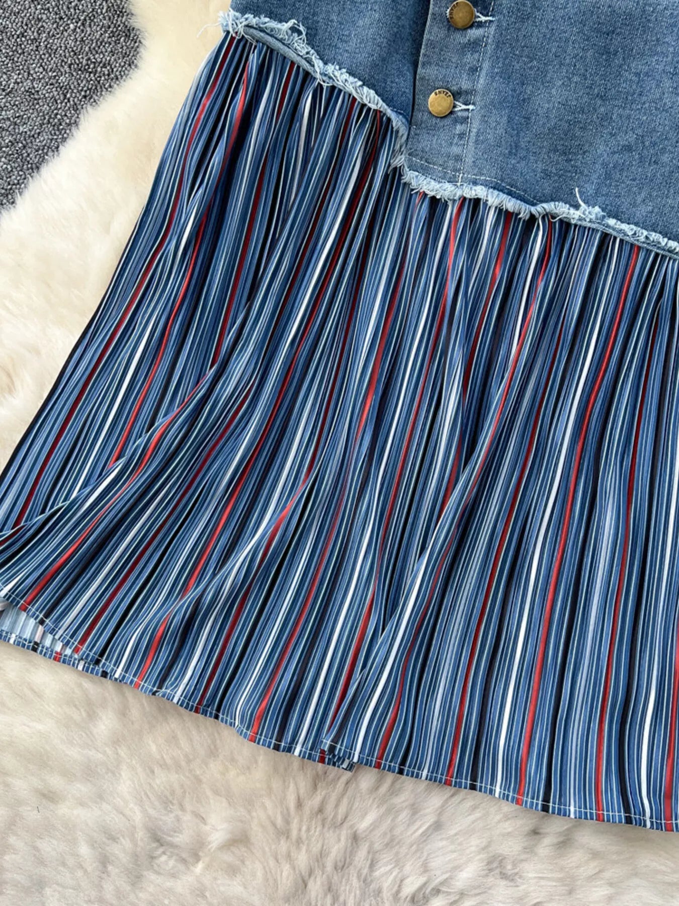 Striped patchwork denim skirt from Trendsi featuring mixed patterns and a stylish, casual design.