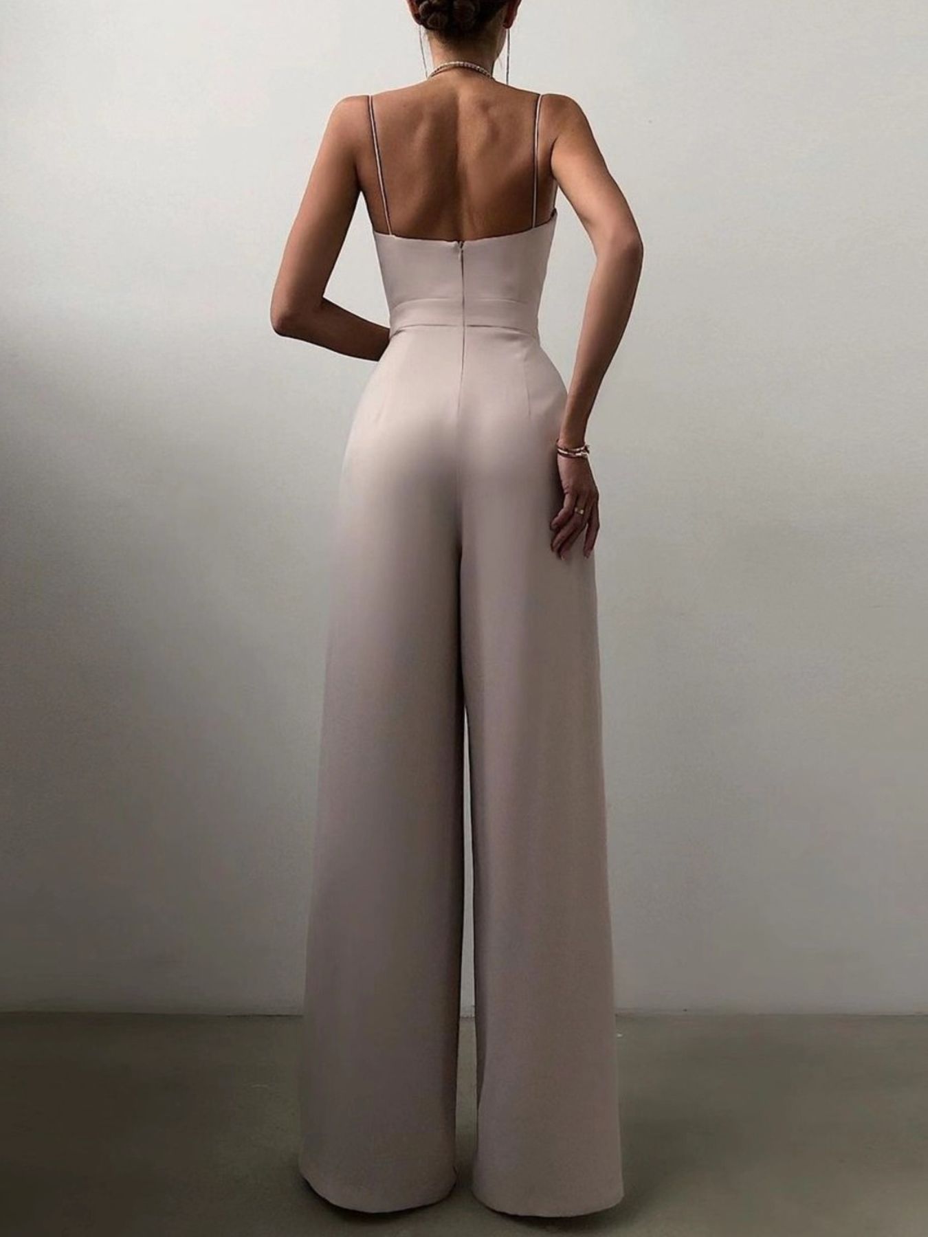 Trendsi spaghetti strap wide-leg jumpsuit with a fitted bodice and flowing pant legs, stylish and perfect for casual or dressy wear.