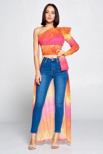 Colorful tie dye one-shoulder top from Toshe Women's Fashions displayed on a hanger with vibrant fabric patterns.