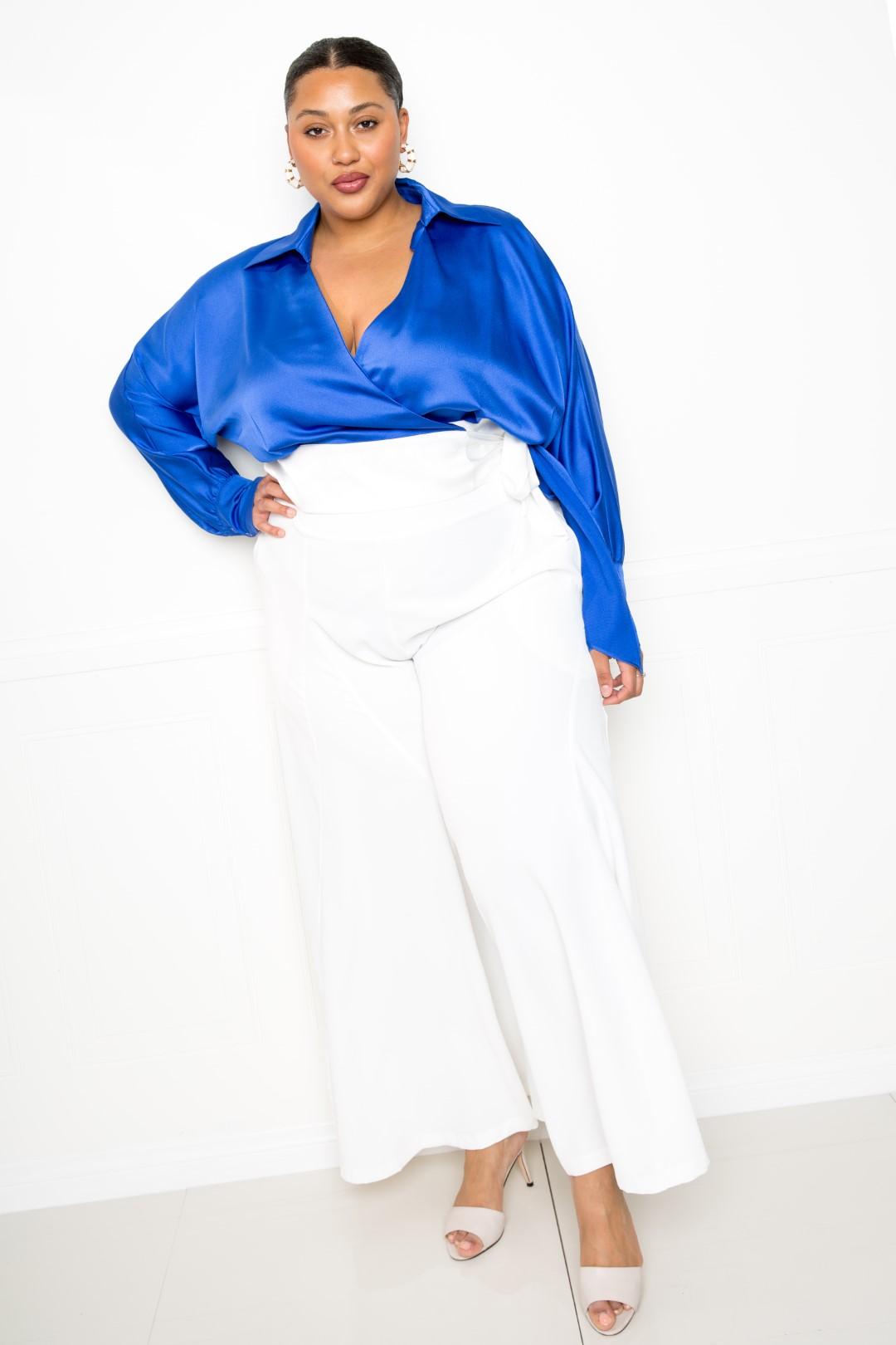White palazzo pants from Toshe Women's Fashions, flowing wide-leg design with comfortable fabric, shown on a model.