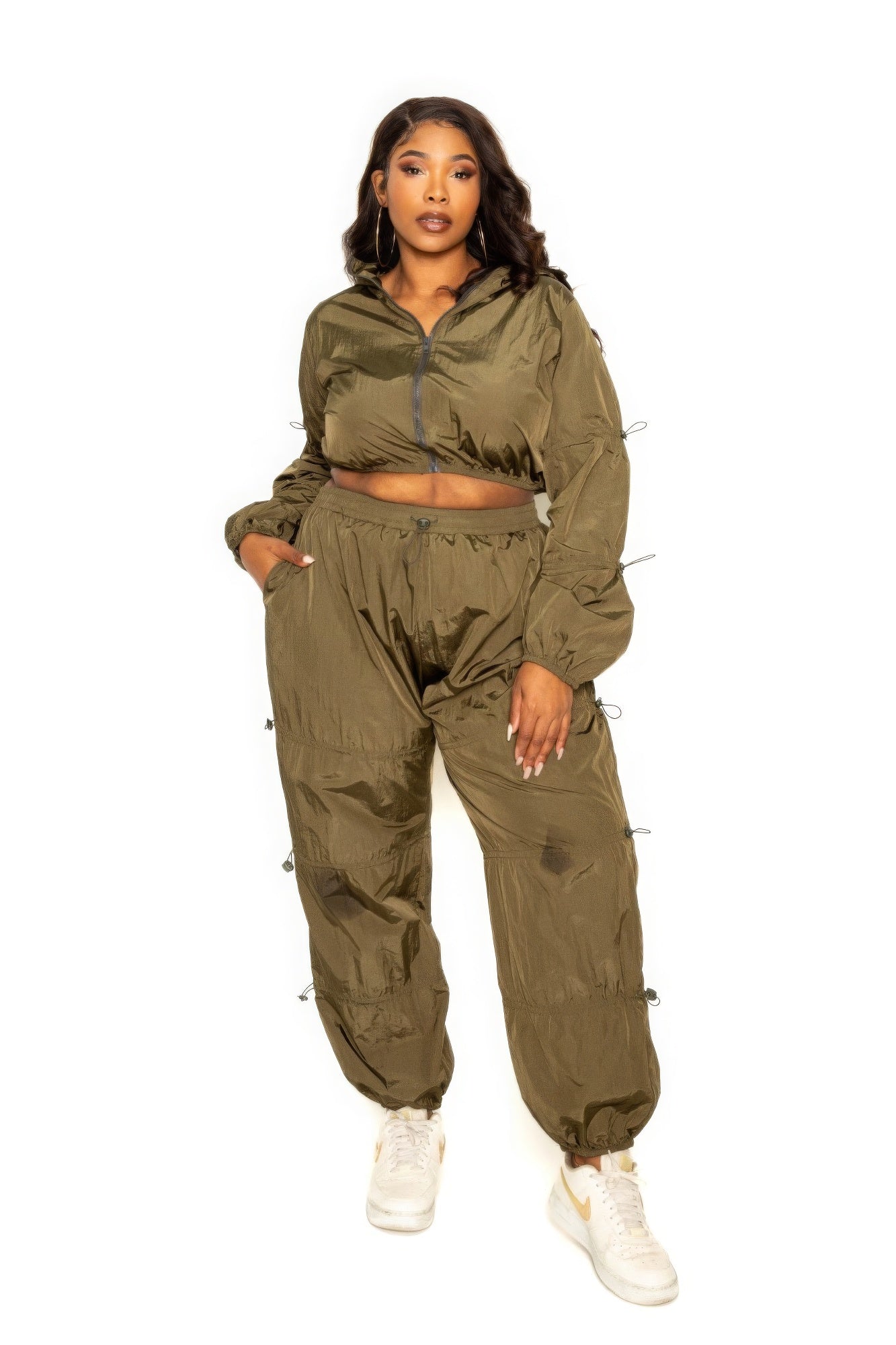 Toshe women's cropped zip-up top and pants set with cord lock detail, casual athletic wear, stylish matching loungewear ensemble.