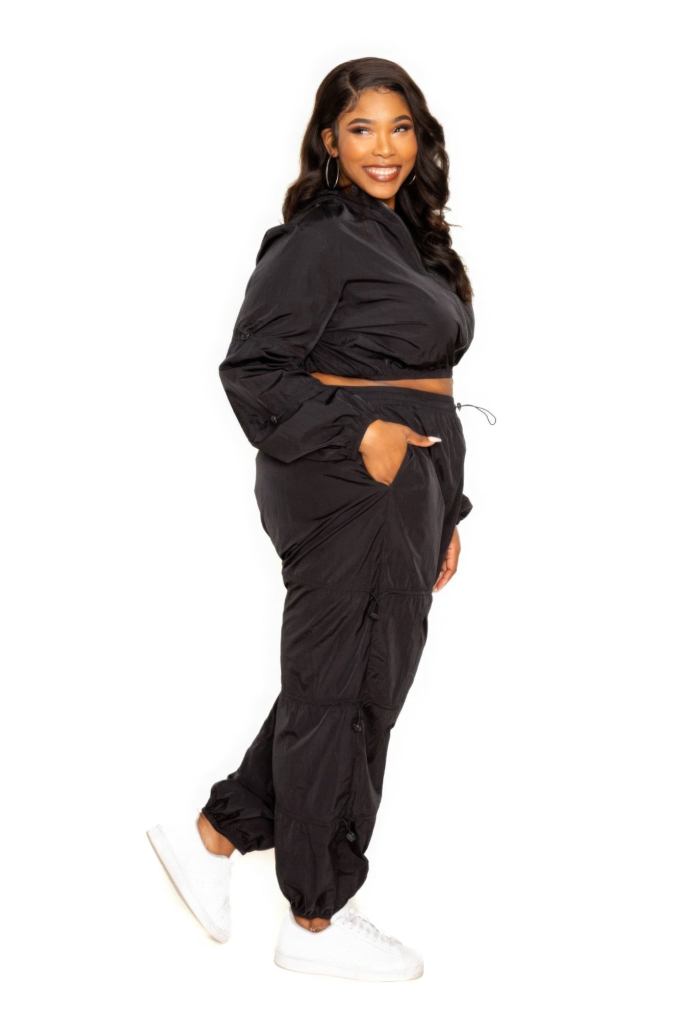 Toshe Women's Fashions cropped zip-up top and pants set with cord lock details, featuring a coordinated casual outfit.