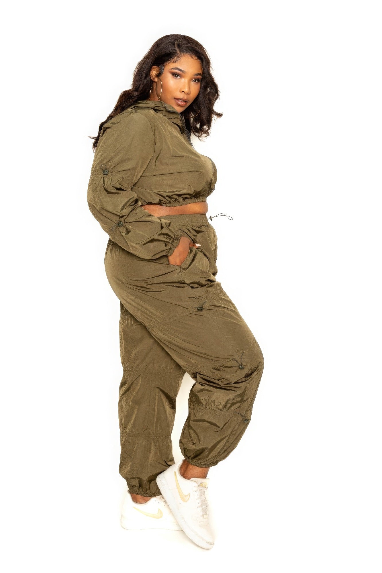 Toshe women's cropped zip-up top and pants set with cord lock detail, casual activewear in black, front view.
