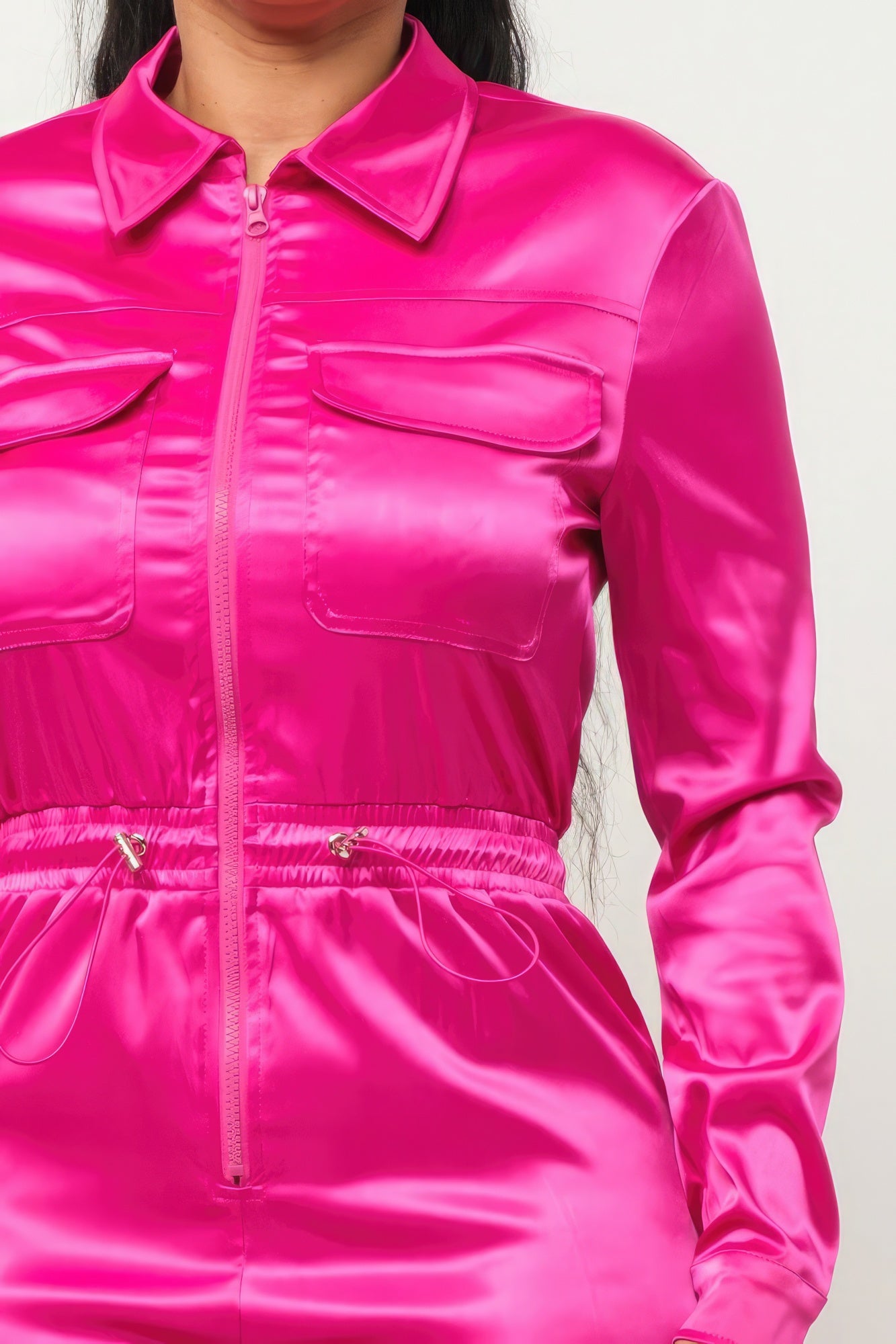 Fuschia zipper pocketed jumpsuit by Toshe Women's Fashions, featuring a fitted design with front zipper and side pockets.