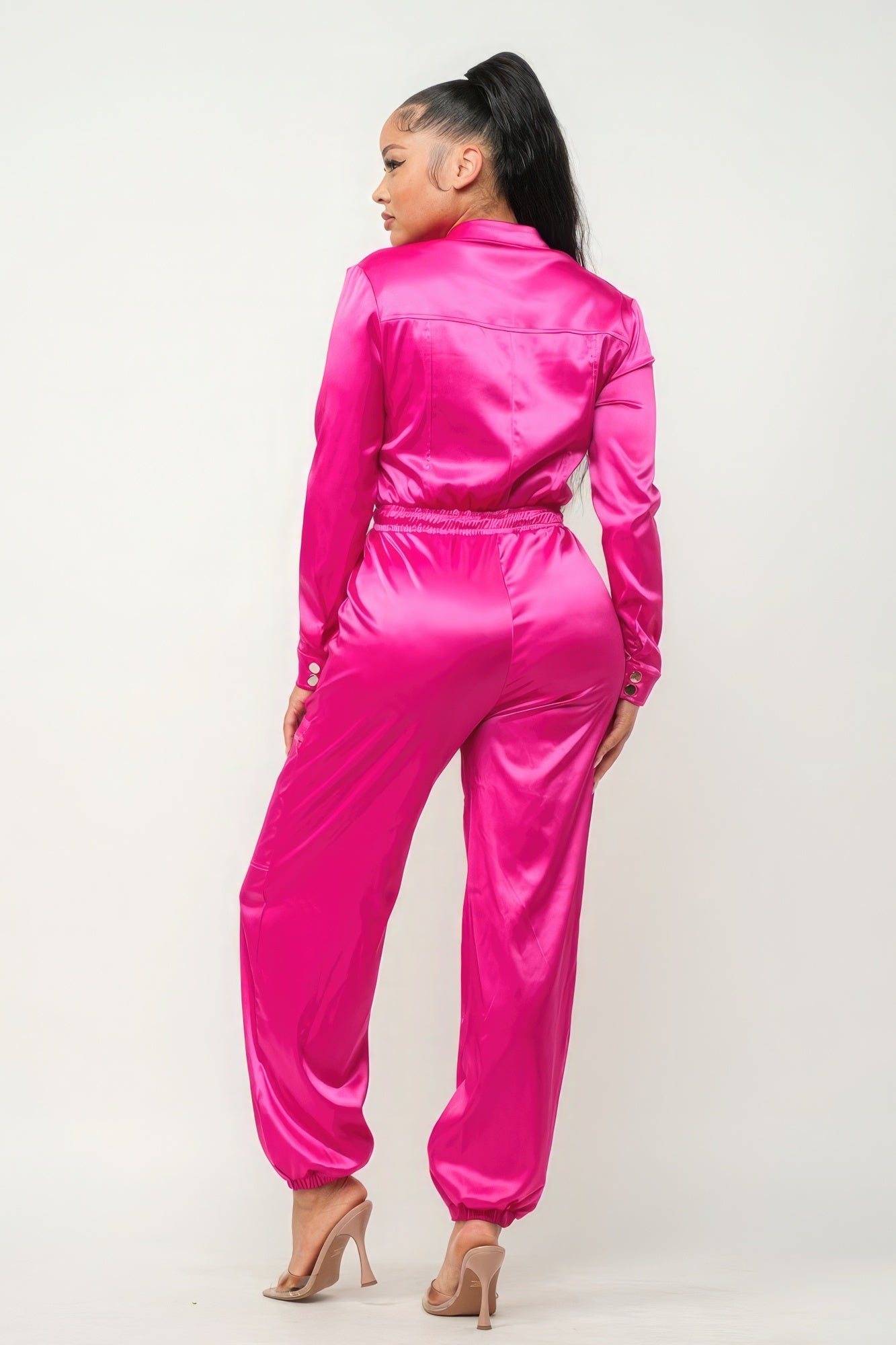 Fuchsia zipper pocketed jumpsuit by Toshe Women's Fashions featuring a fitted style with front zipper and side pockets.