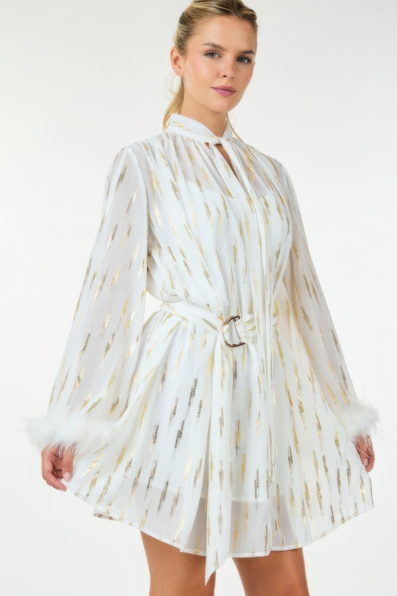 Metallic sheer mini dress by Toshe Women's Fashions, close-up of shimmering, lightweight fabric with a fitted silhouette.