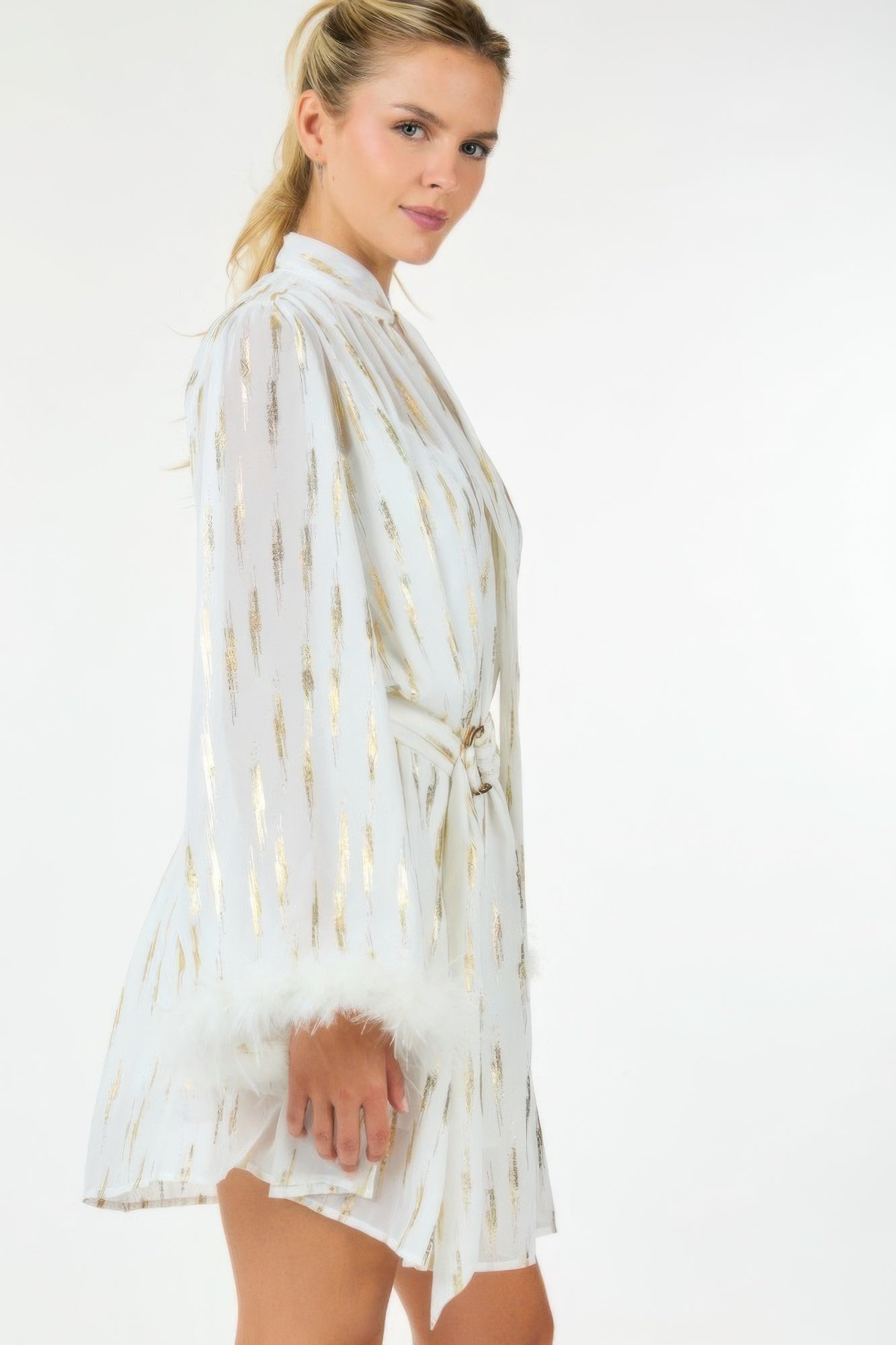Metallic sheer mini dress from Toshe Women's Fashions, featuring a shiny, form-fitting design with long sleeves and a stylish neckline.
