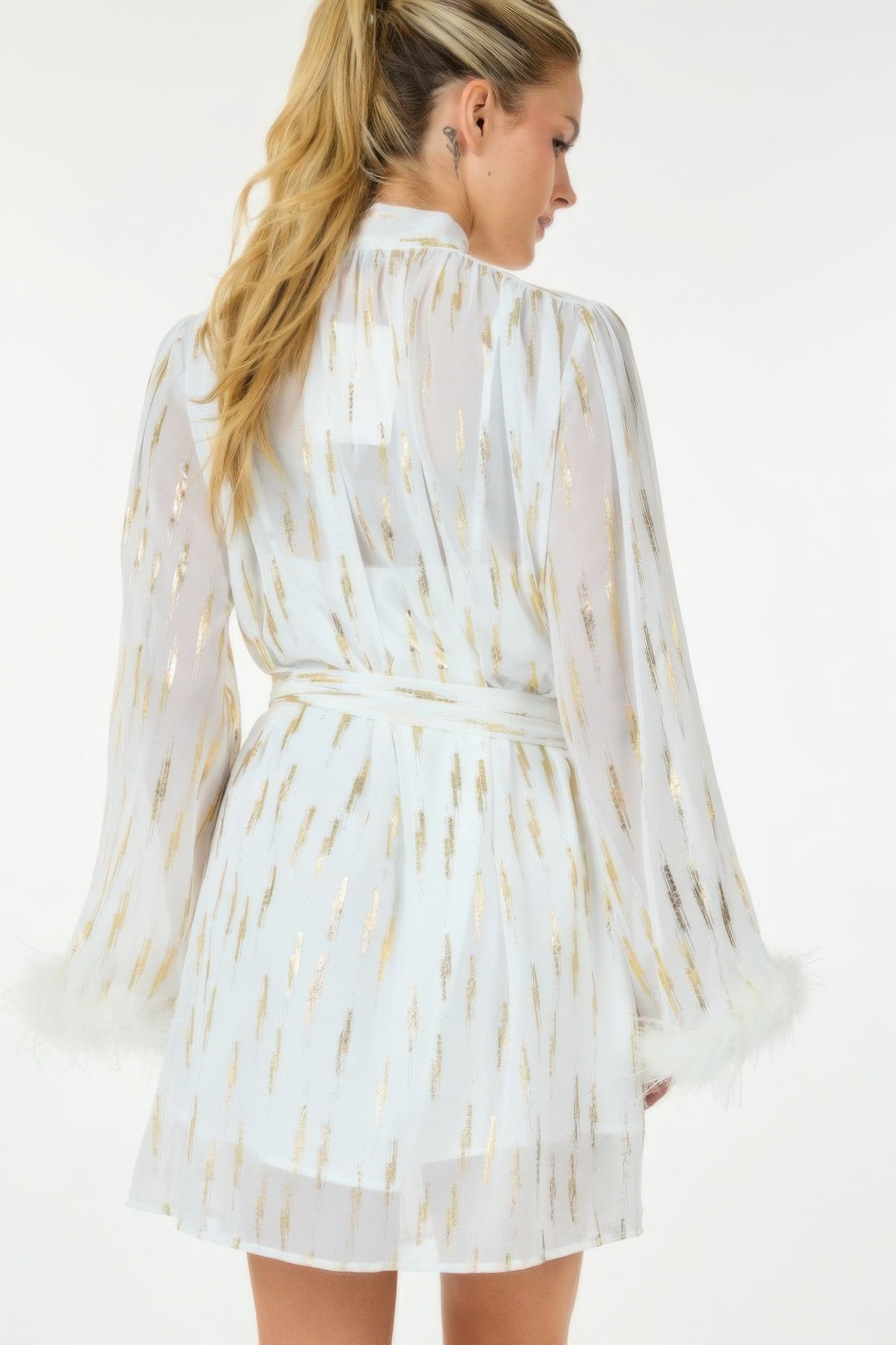 Metallic sheer mini dress by Toshe Women's Fashions featuring shiny fabric and a fitted silhouette, shown on a model.