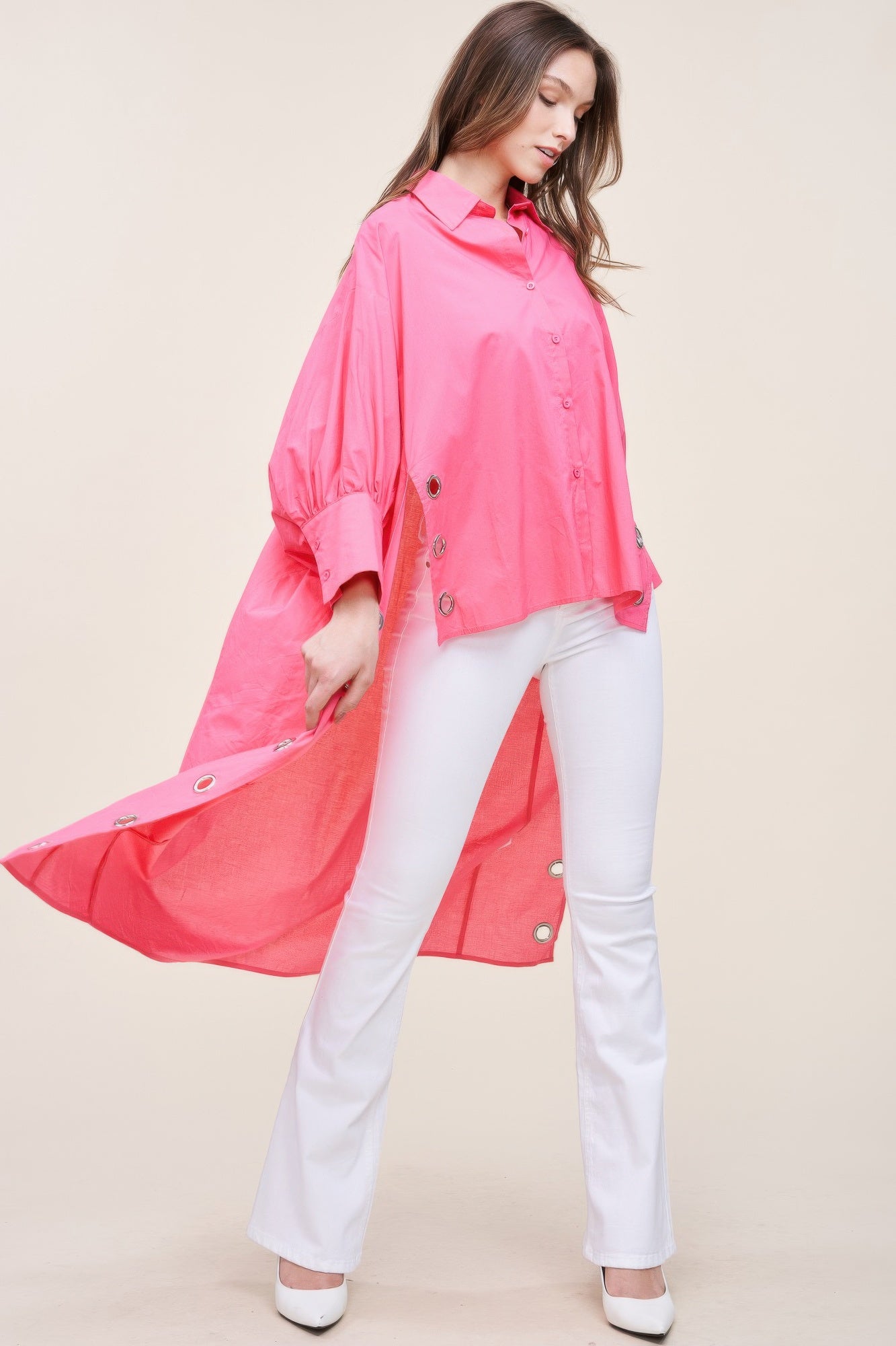 Oversized asymmetrical shirt by Toshe Women's Fashions, featuring a loose fit and unique hemline, displayed on a hanger.