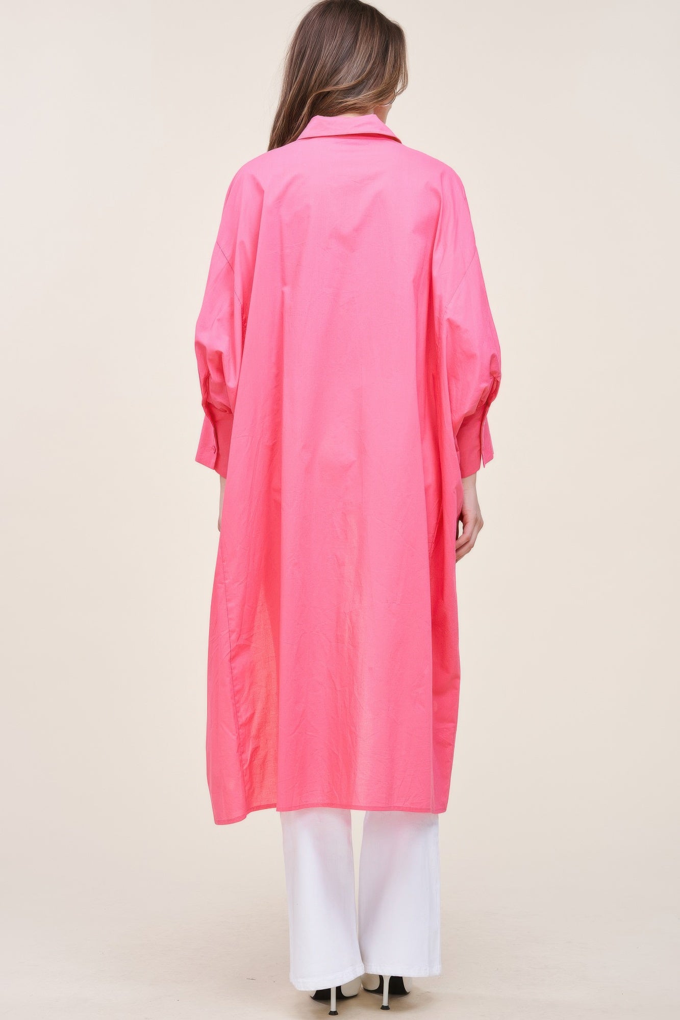 Oversized asymmetrical shirt by Toshe Women's Fashions featuring a loose fit, draped design, and unique hemline in soft fabric.