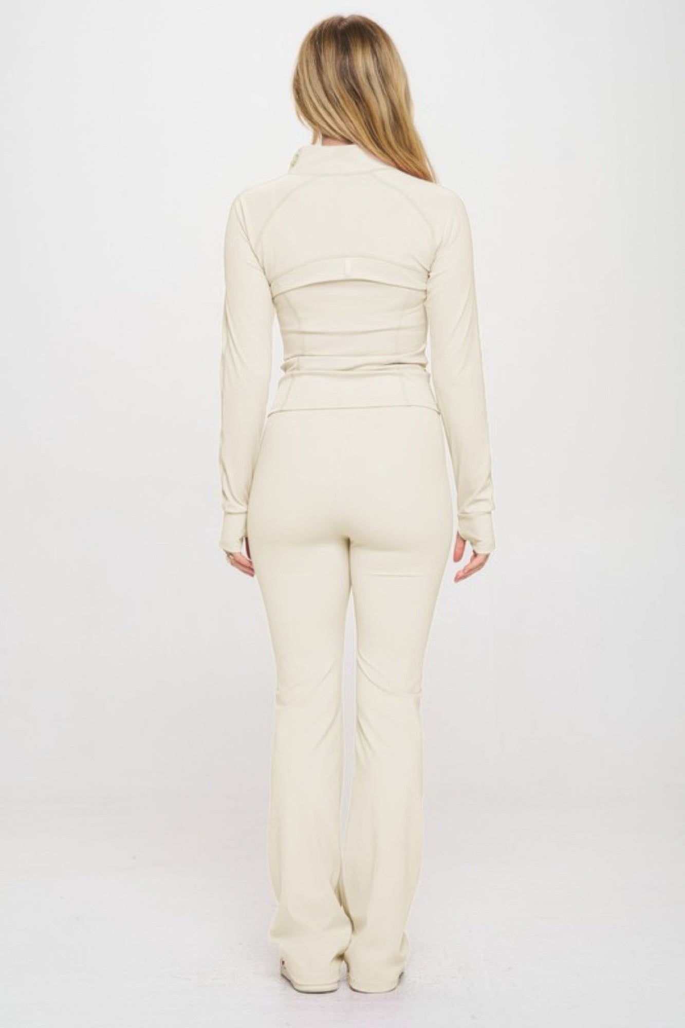 Fitted zipper jacket and pants set by Toshe Women's Fashions, shown in black with silver zipper details on a model.