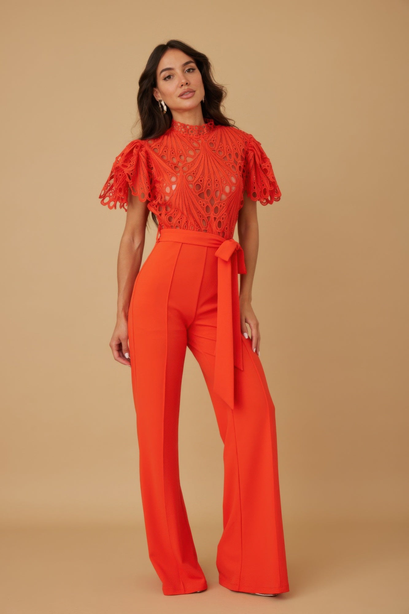 Crochet jumpsuit by Toshe Women's Fashions featuring a stylish, fitted design with intricate crochet patterns.
