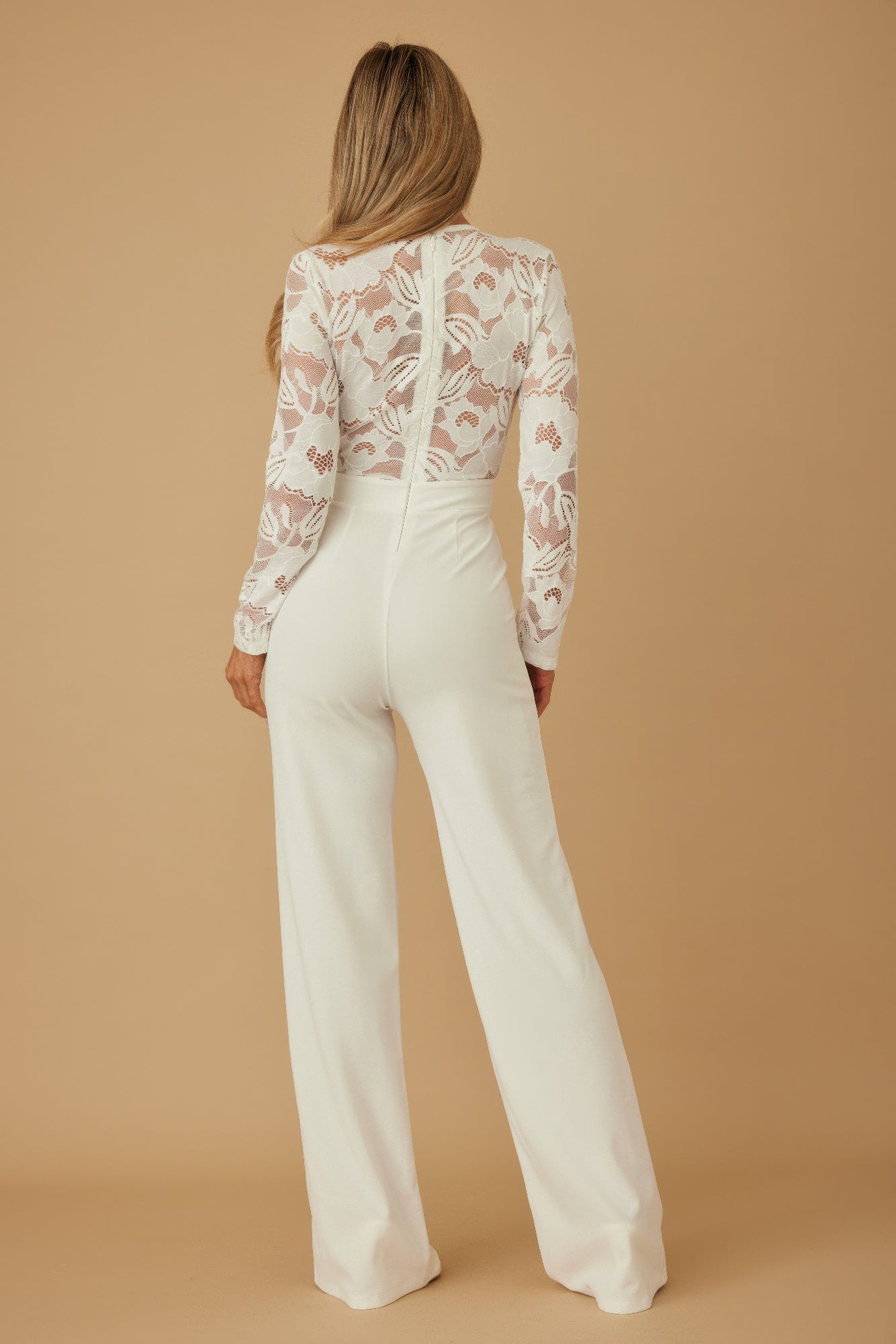 Lace crochet long sleeve jumpsuit by Toshe Women's Fashions featuring intricate lace details and a fitted silhouette.