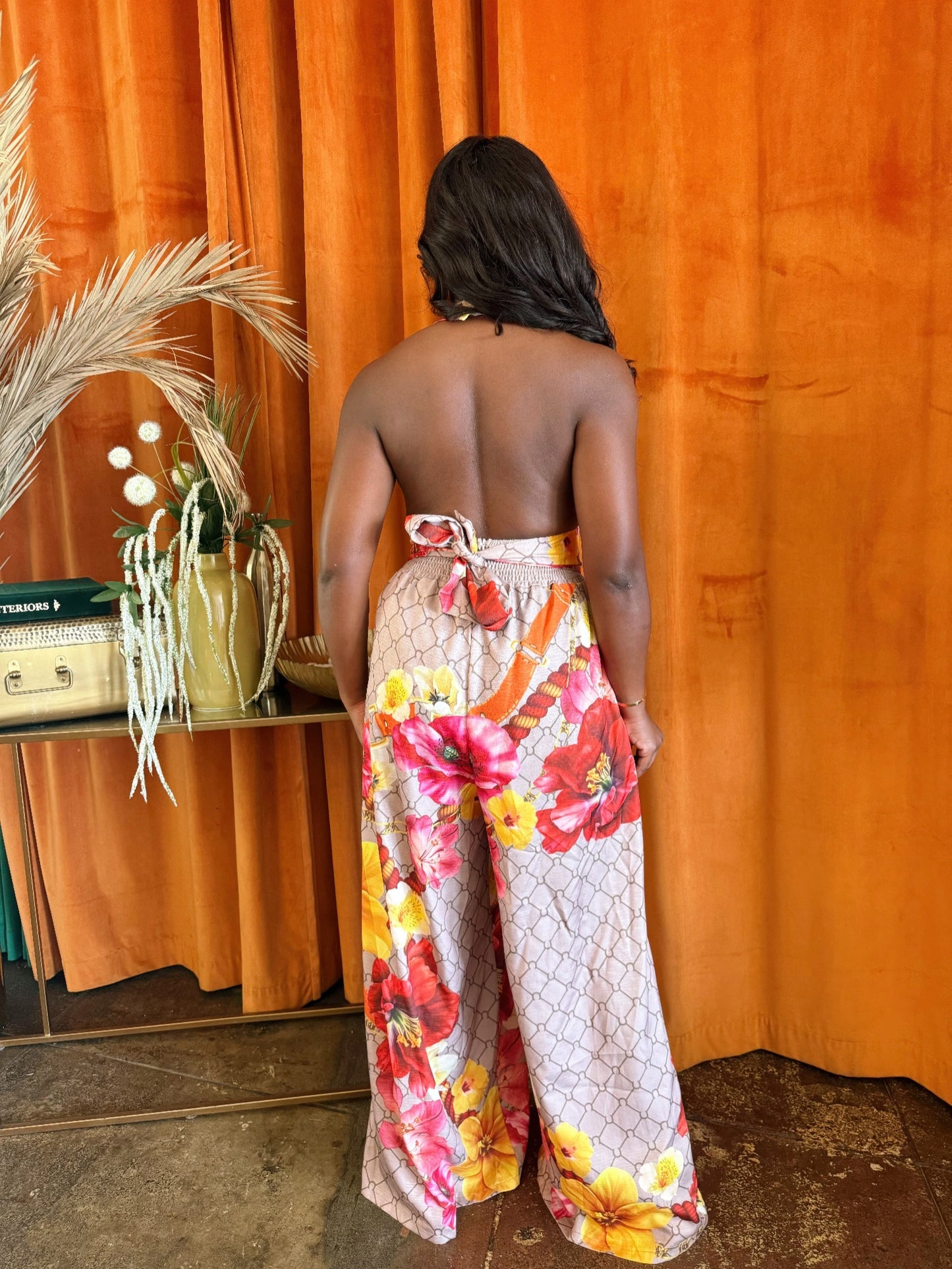 Toshe Women's Fashions Paradise Bloom jumpsuit with floral print, sleeveless design, and wide-leg pants on a white background.