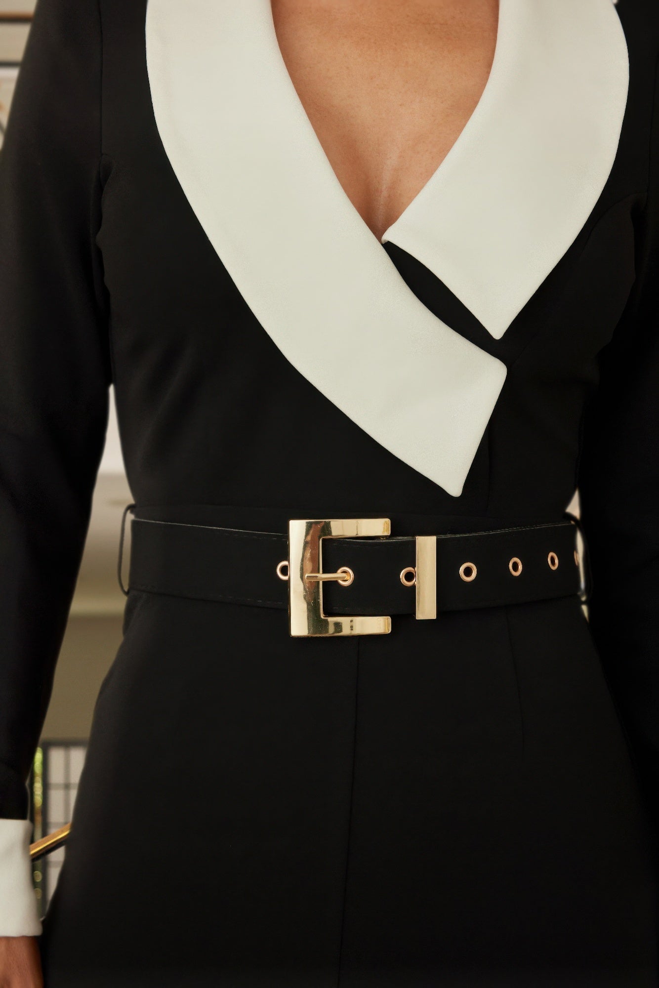 Black and white long sleeve jumpsuit by Toshe Women's Fashions, featuring a fitted design with a high neckline.