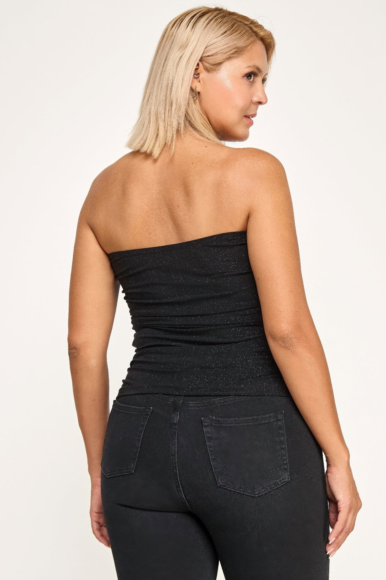 Strapless glitter bandeau top by Toshe Women's Fashions, featuring sparkly fabric and fitted design, displayed on a white background.