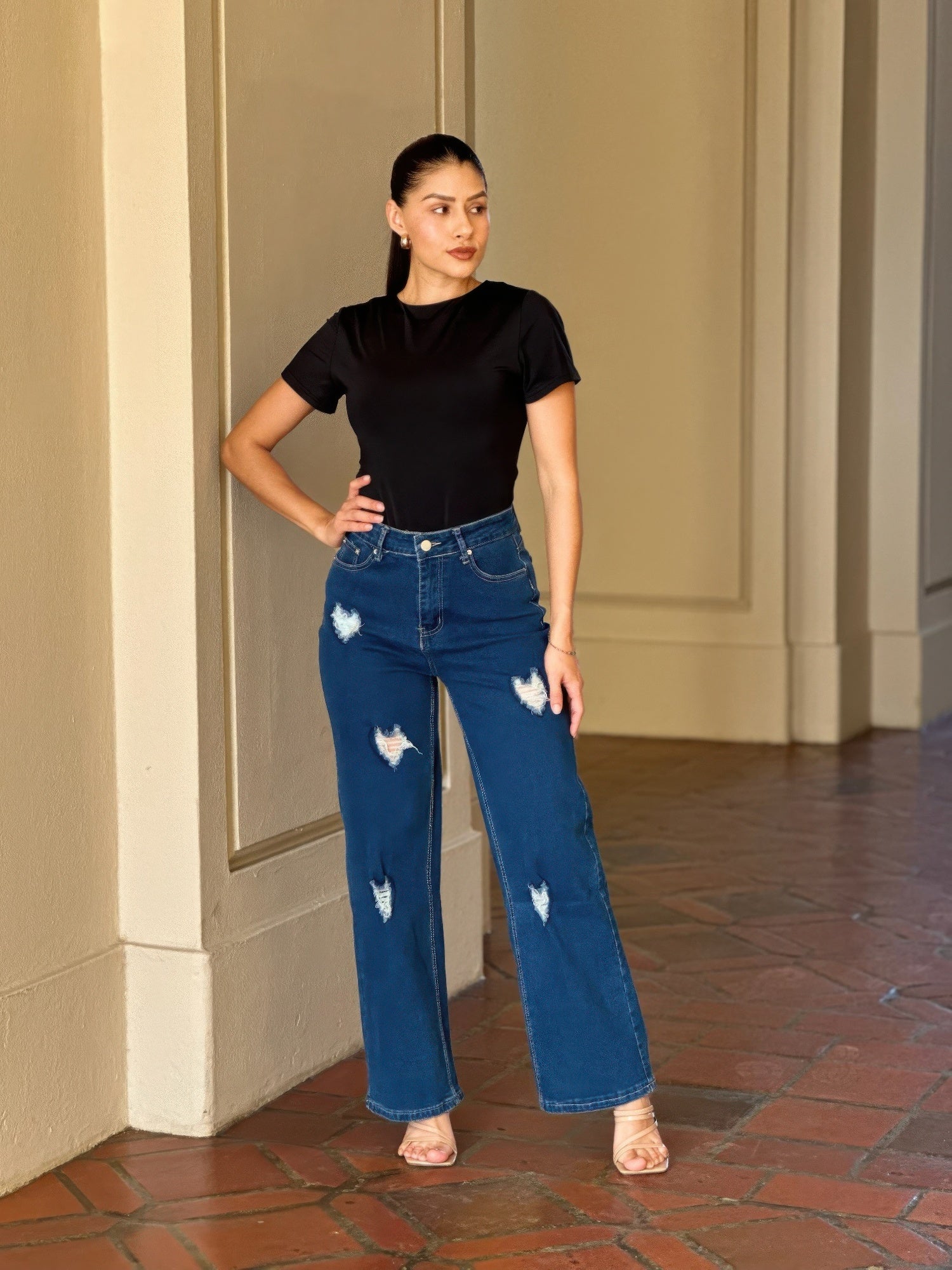 Distressed wide-leg denim jeans with embroidered heart design by Toshe Women's Fashions, showcasing fashionable casual style.