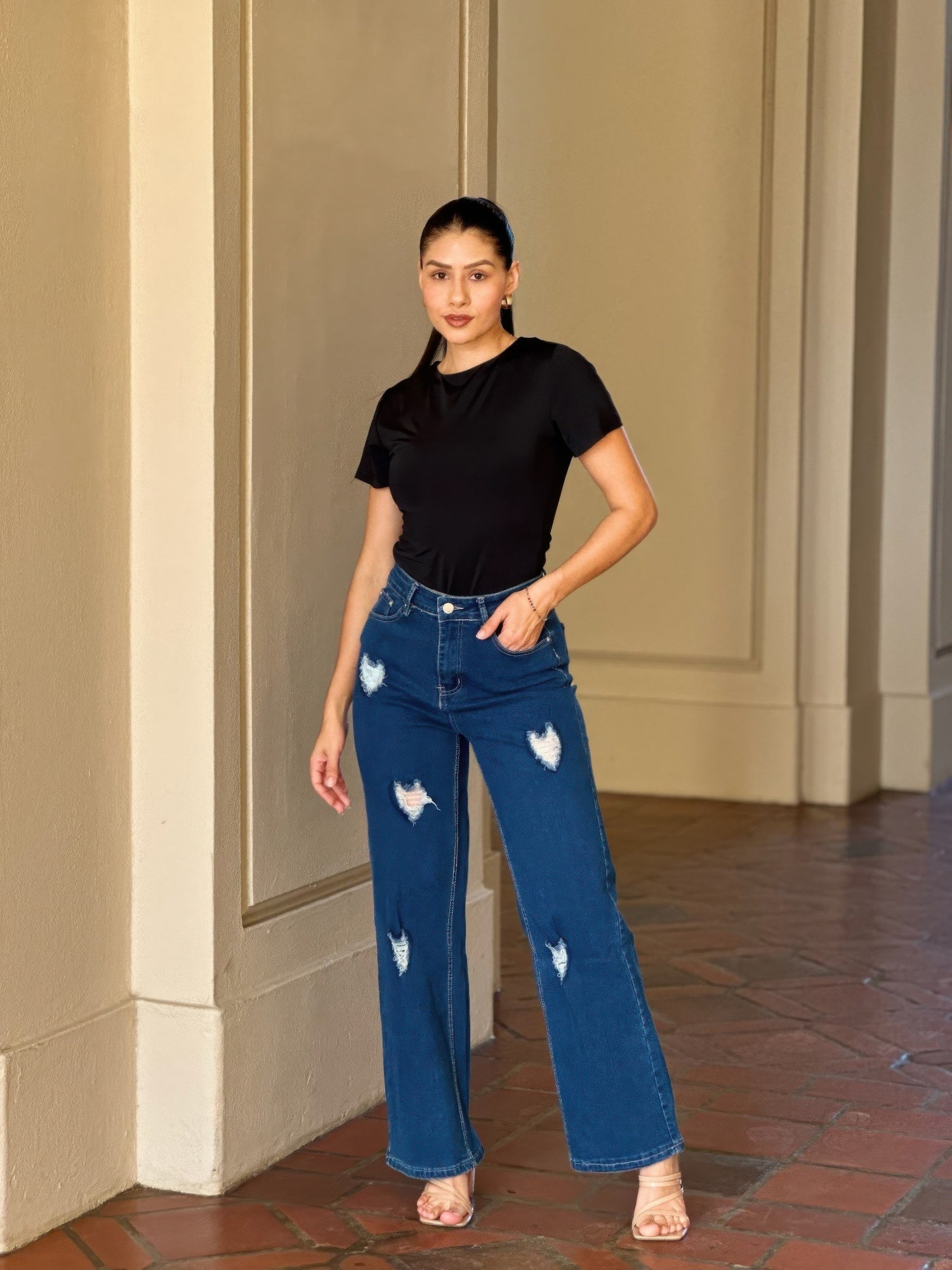 Distressed wide leg denim jeans with embroidered heart details from Toshe Women's Fashions, shown in a casual front view.