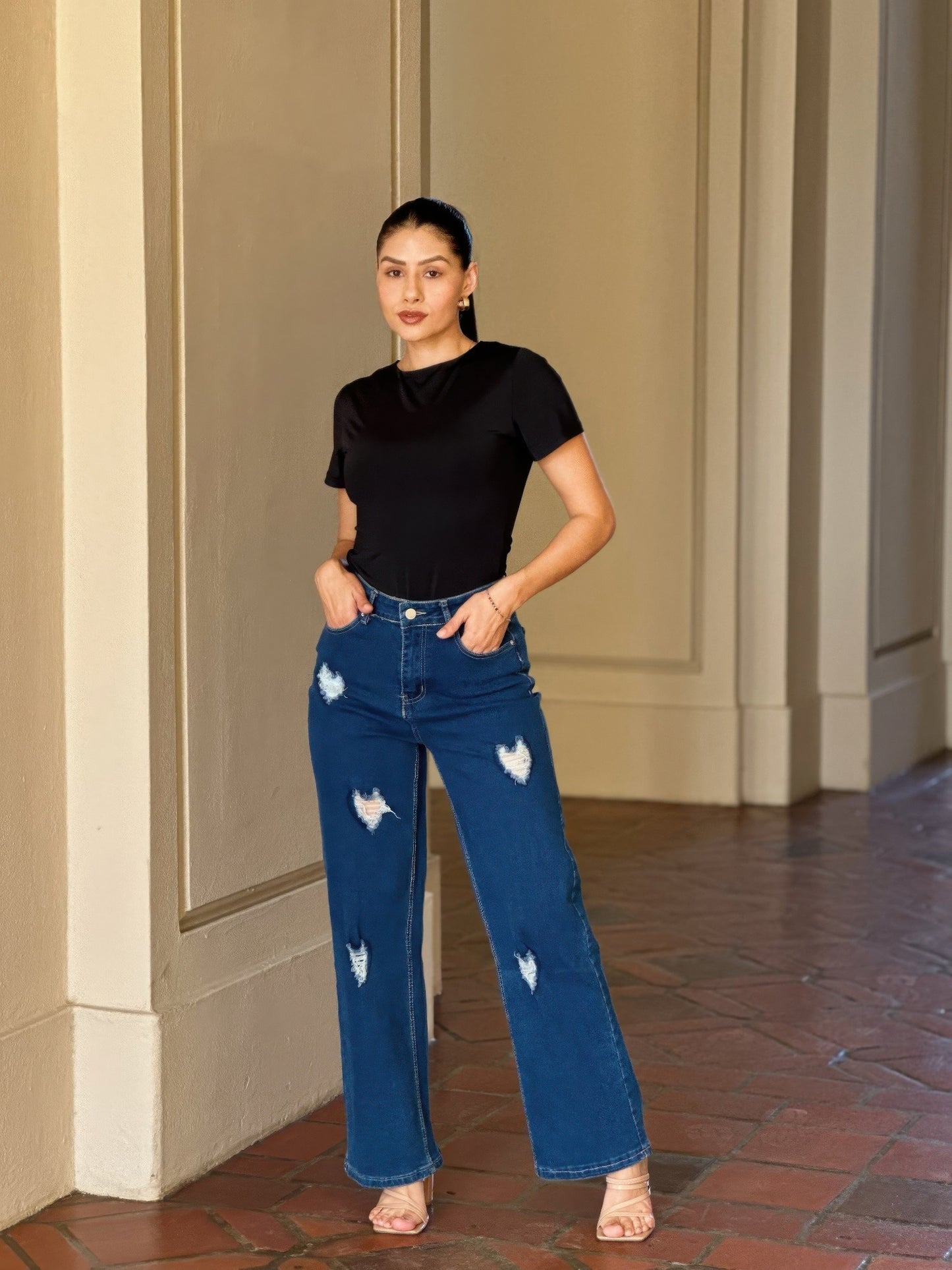 Distressed wide-leg denim jeans with embroidered heart design by Toshe Women's Fashions, showing front view with fading details.