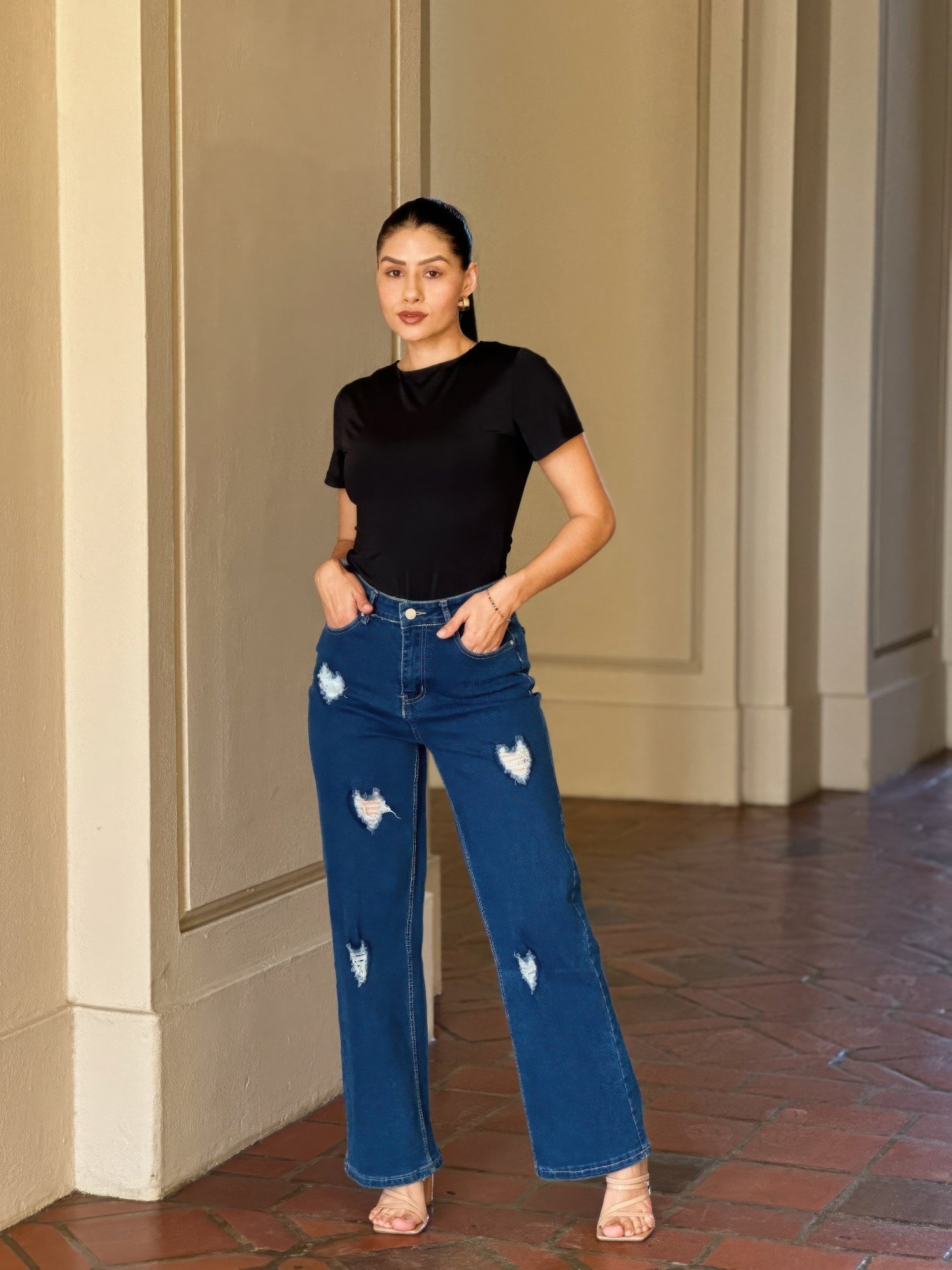 Distressed wide-leg denim jeans with embroidered heart design by Toshe Women's Fashions, showing front view with fading details.