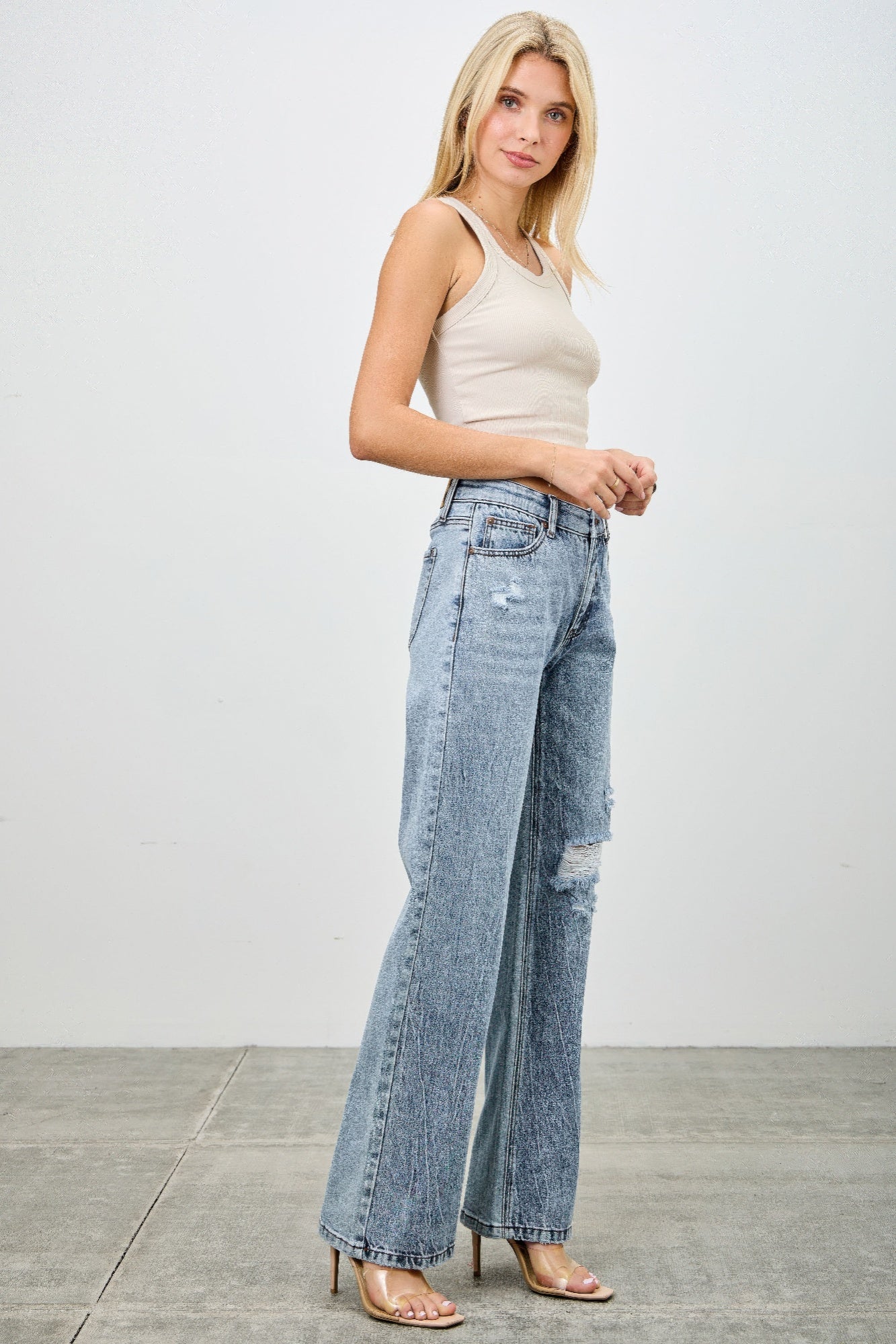 Toshe Women's Fashions mid-rise relaxed straight jeans with distressed hem, showcasing a casual denim look.