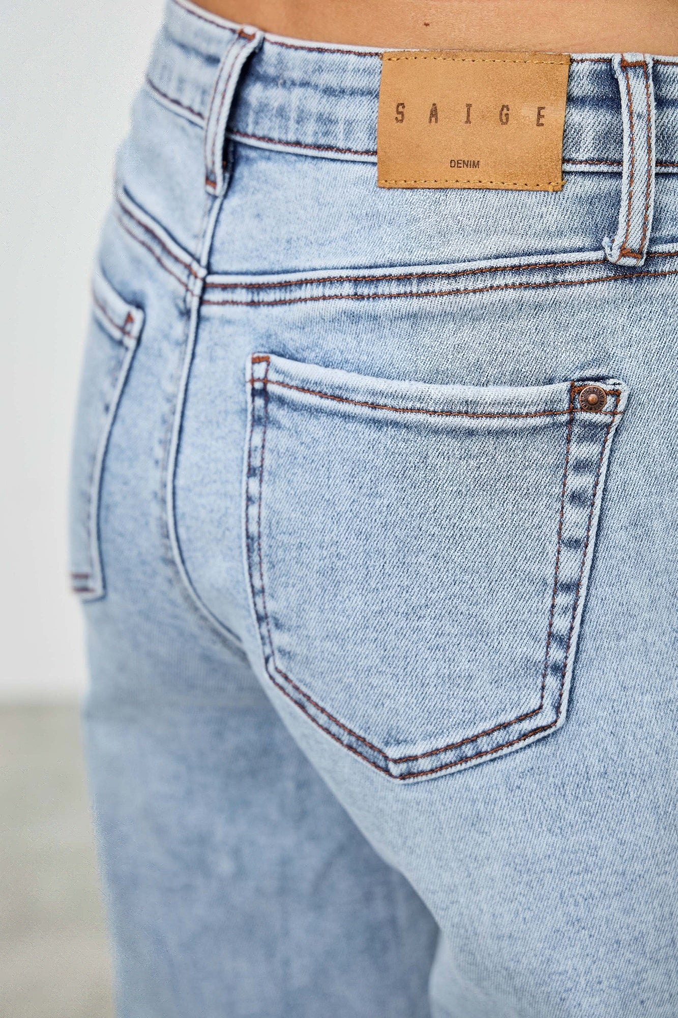 Toshe Women's Fashions mid-rise relaxed straight jeans with distressed hem, denim fabric, and casual fit.