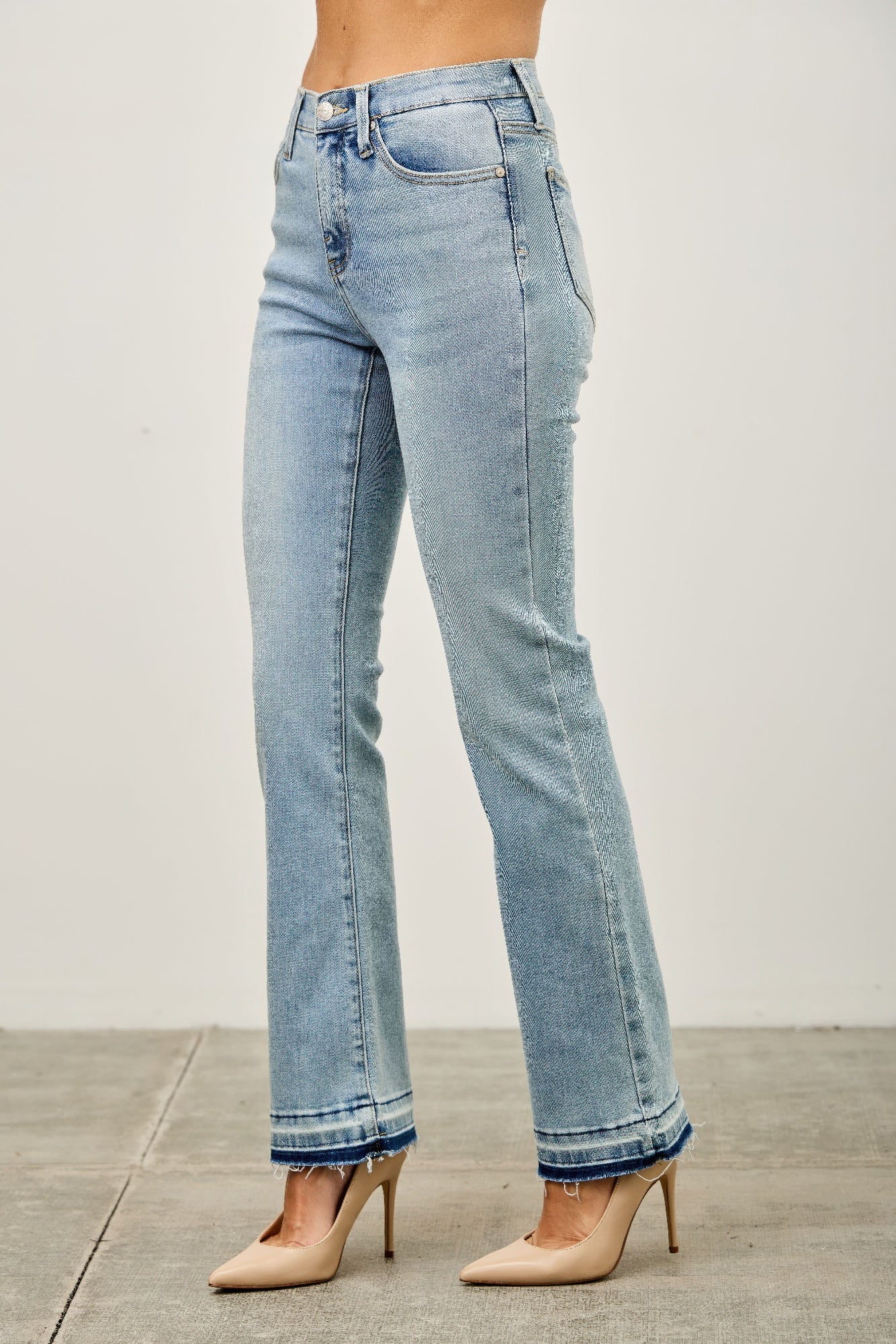 Toshe Women's Fashions mid-rise flare jeans with released hem, showcasing a stylish denim fit and trendy flare leg design.