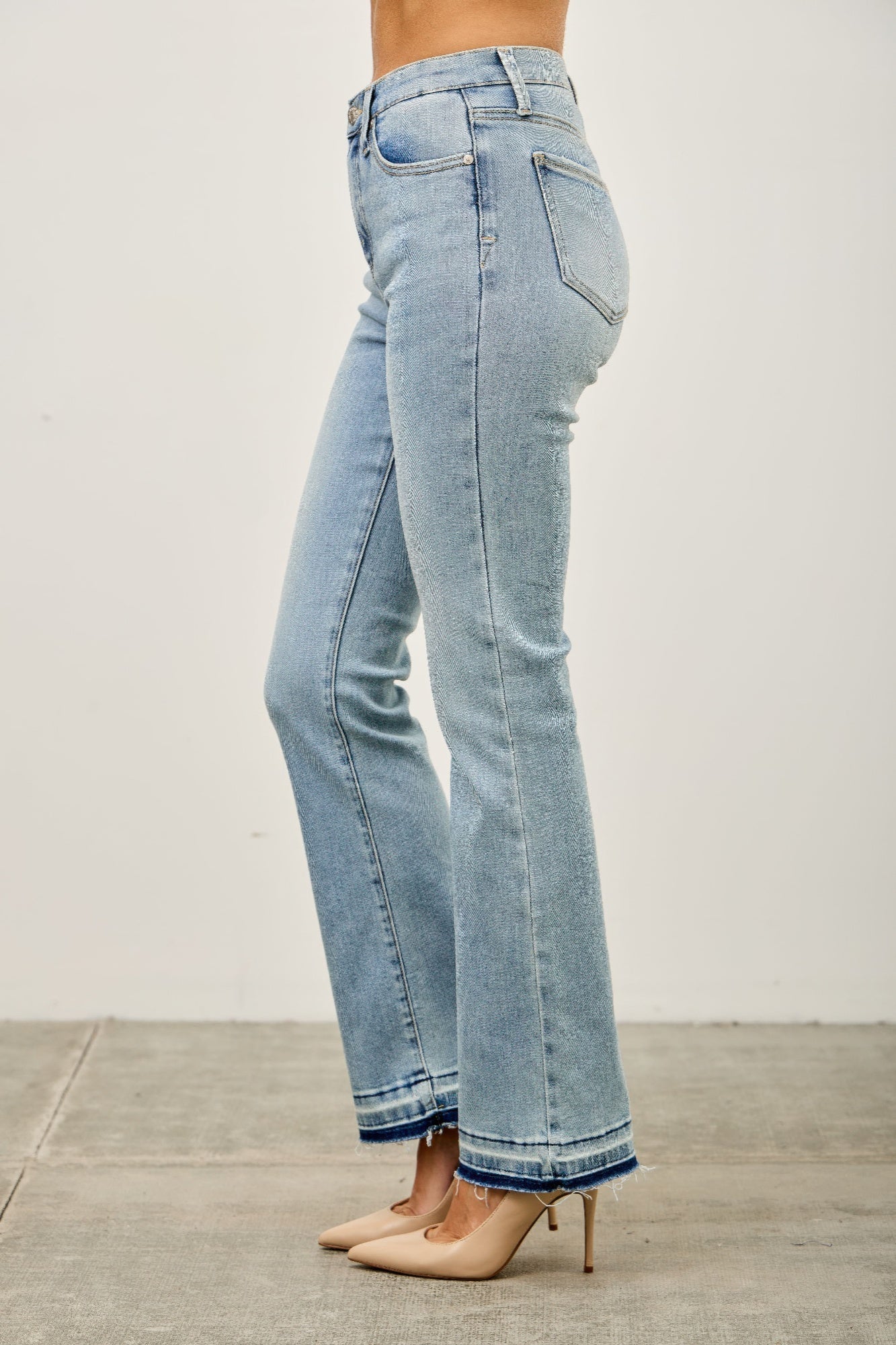 Toshe Women's Fashions mid-rise flare jeans with released hem, showing the stylish fit and detailed hem design.