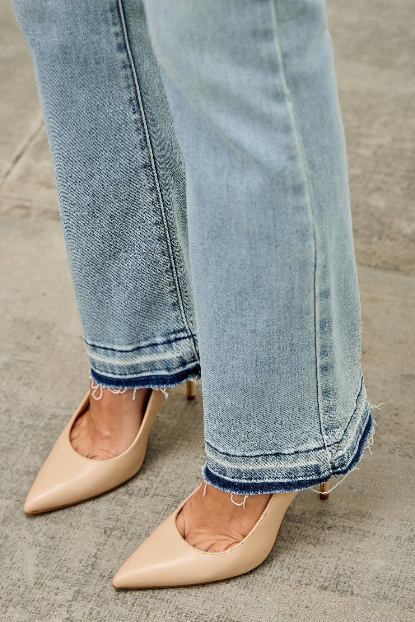 Mid-rise flare jeans with released hem from Toshe Women's Fashions, shown with a relaxed fit and stylish design.