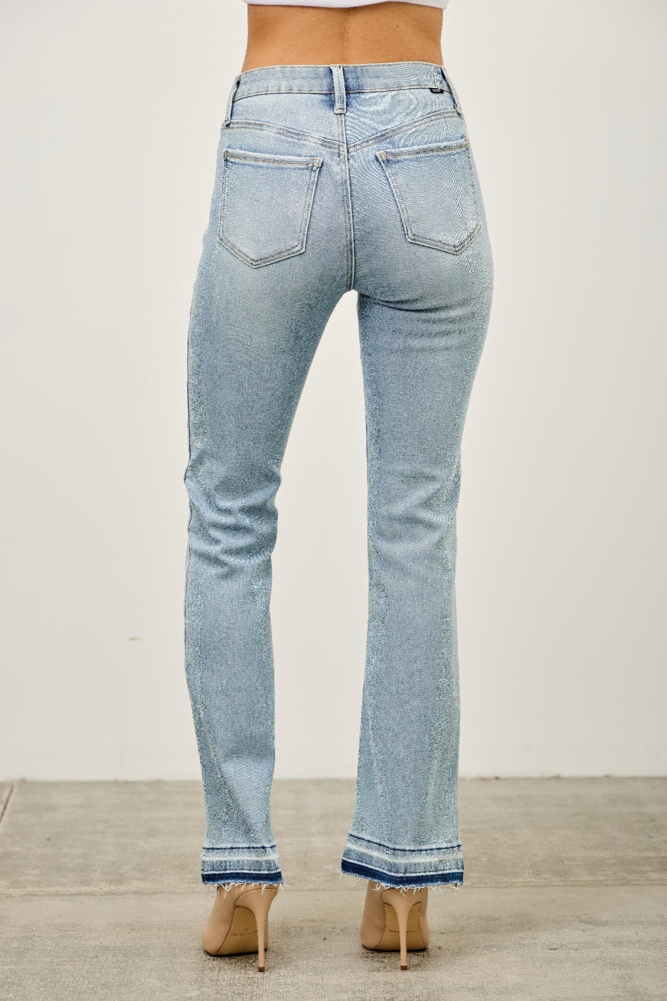 Toshe Women's Fashions mid-rise flare jeans with released hem, shown on a model, in a casual denim style.
