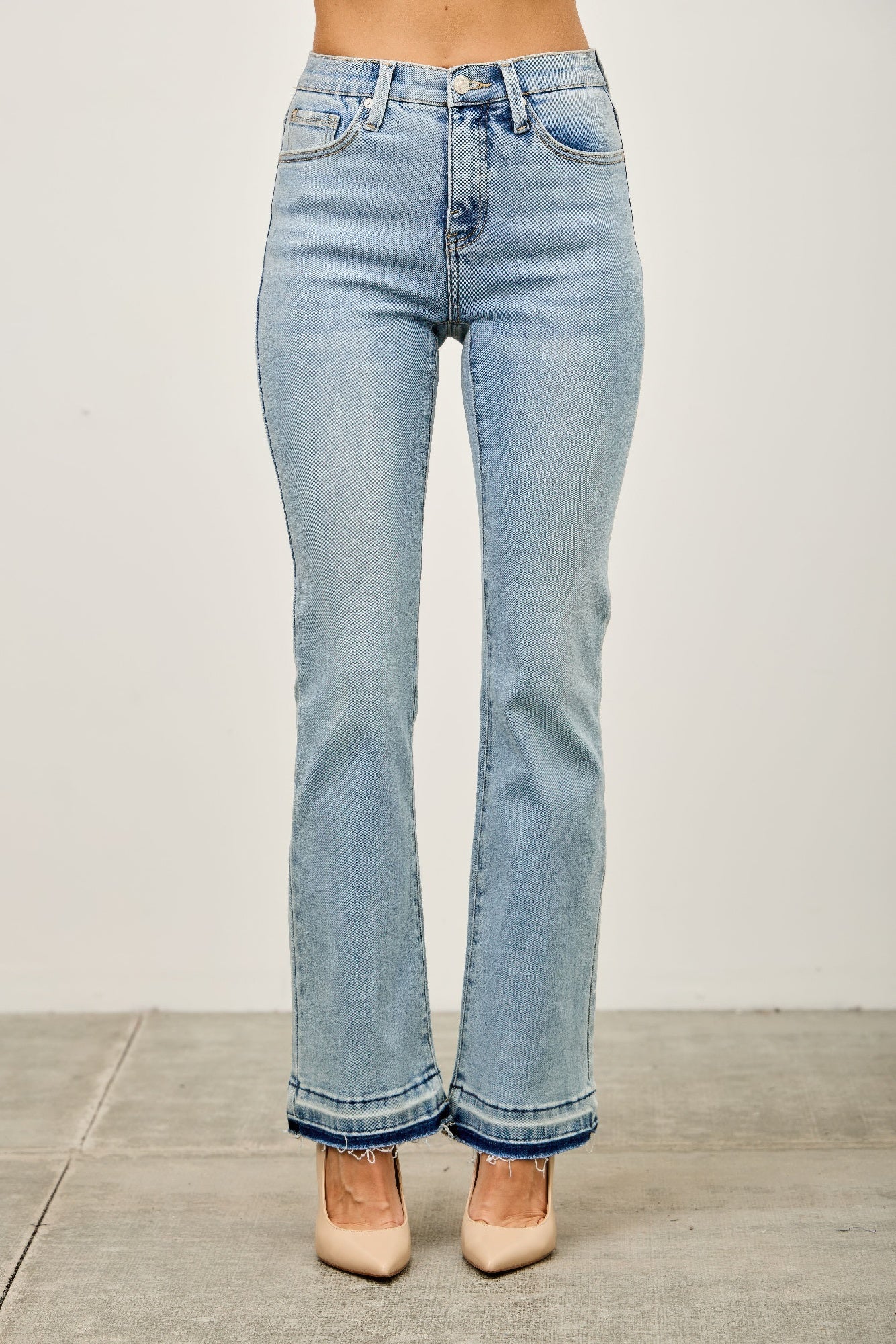 Toshe Women's Fashions mid-rise flare jeans with released hem, showcasing stylish denim silhouette and modern fit.