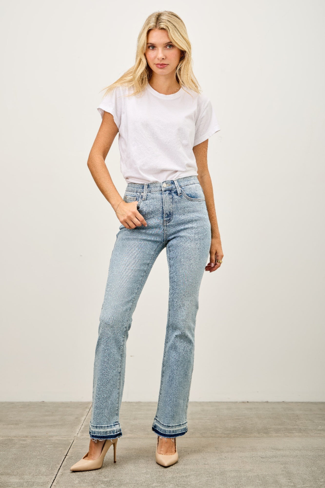 Toshe Women's Fashions mid-rise flare jeans with released hem, shown in a front view, featuring a classic denim look and stylish fit.