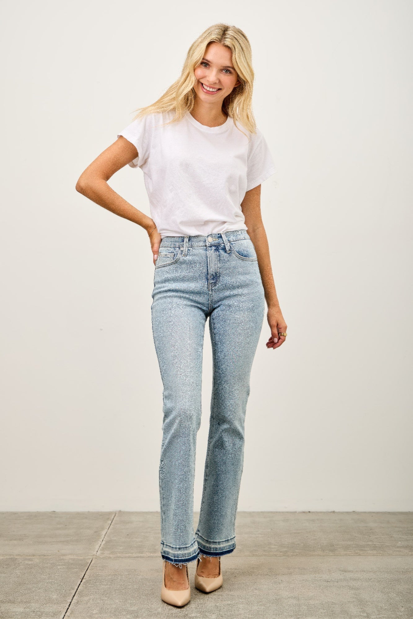 Toshe Women's Fashions mid-rise flare jeans with released hem, showcasing stylish denim with a fitted waist and flared leg design.