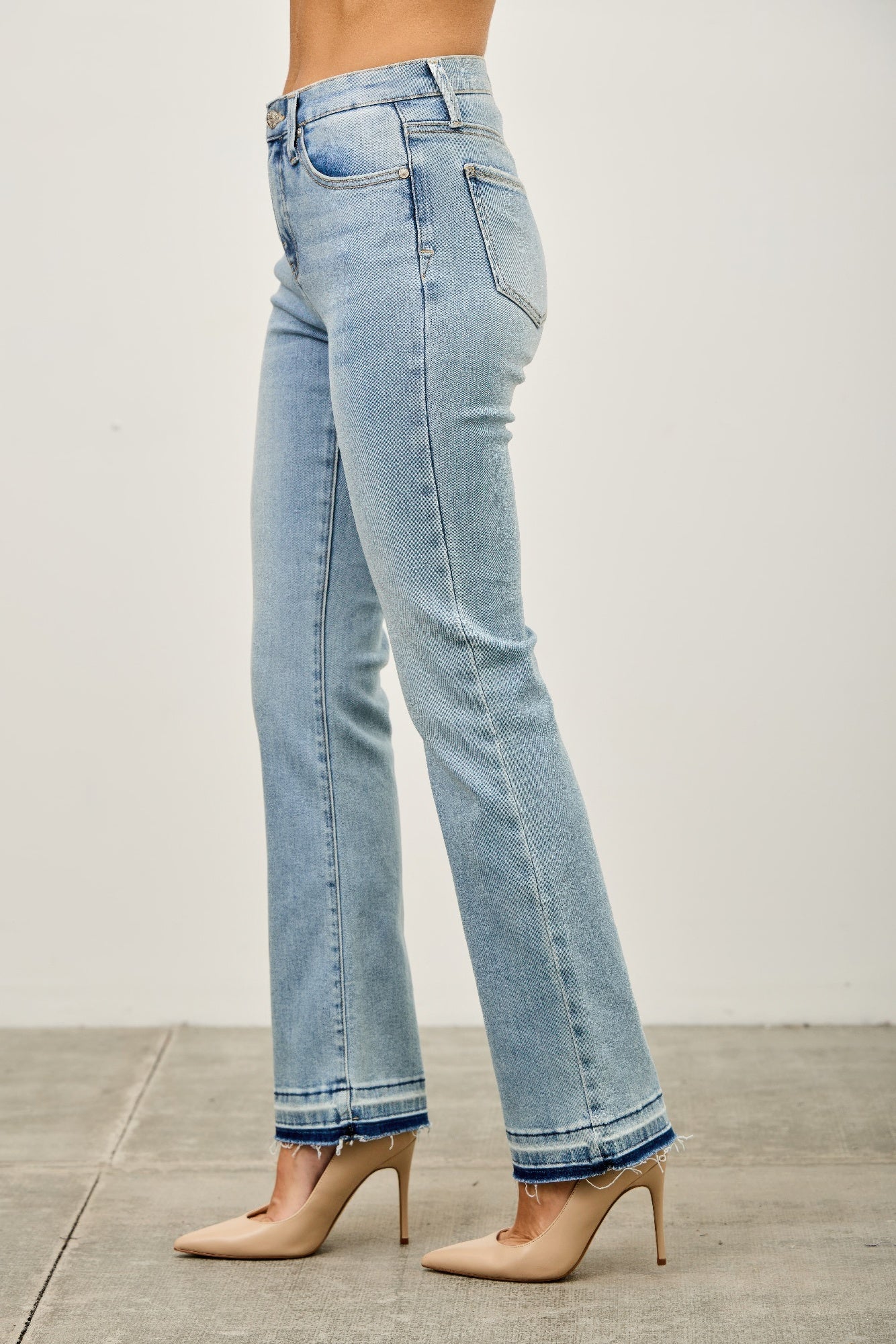 Mid-rise flare jeans with a released hem from Toshe Women's Fashions, featuring a stylish and relaxed fit.