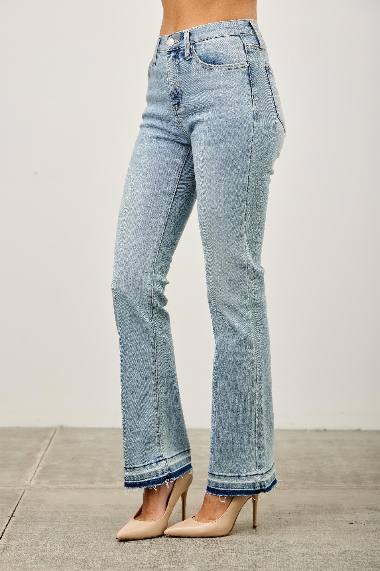 Mid-rise flare jeans with a released hem from Toshe Women's Fashions, showing the stylish fit and hem detail.