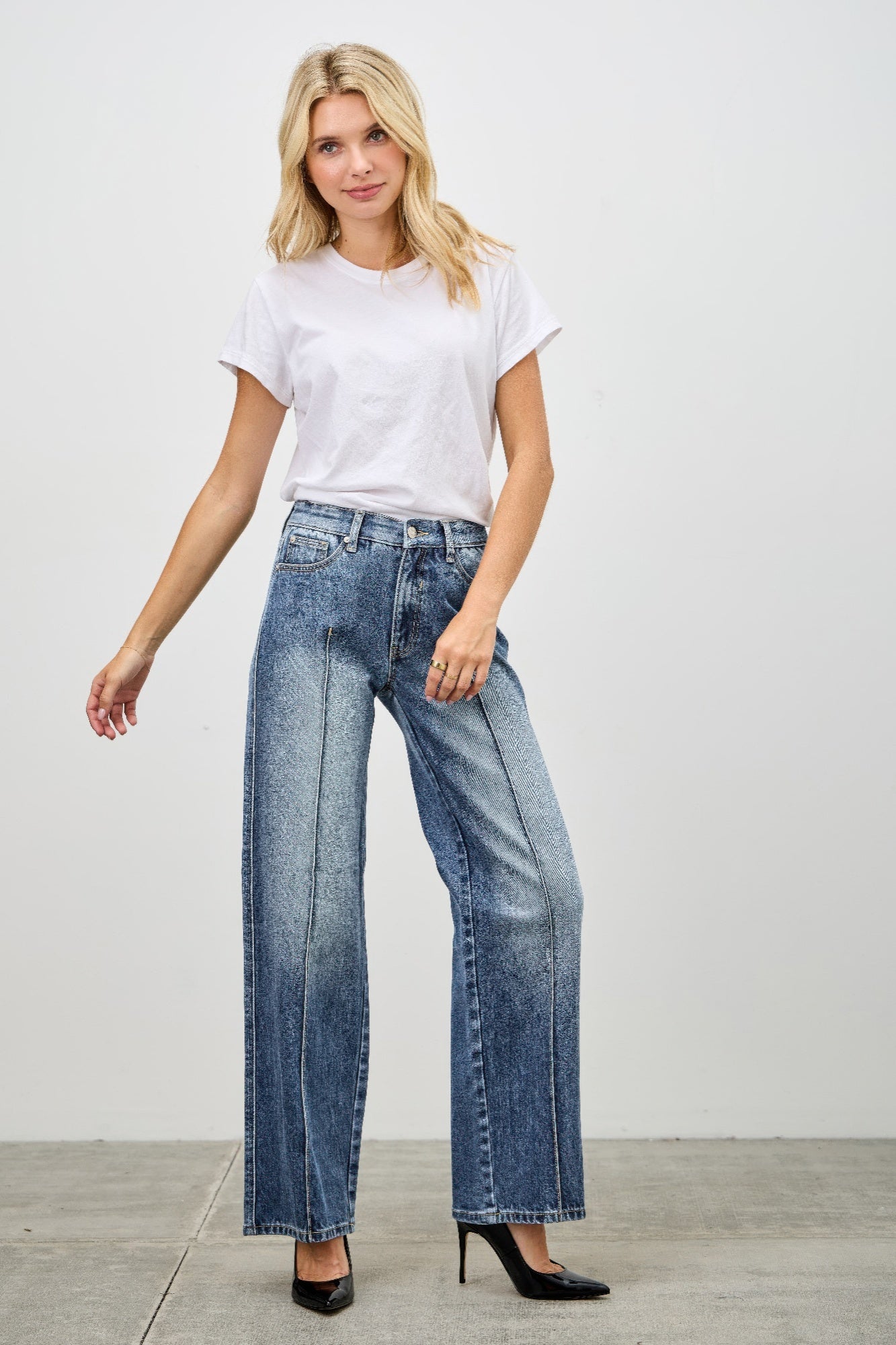 Toshe Women's Fashions mid-rise straight jeans with pintuck detailing, shown on a model, in a casual indoor setting.