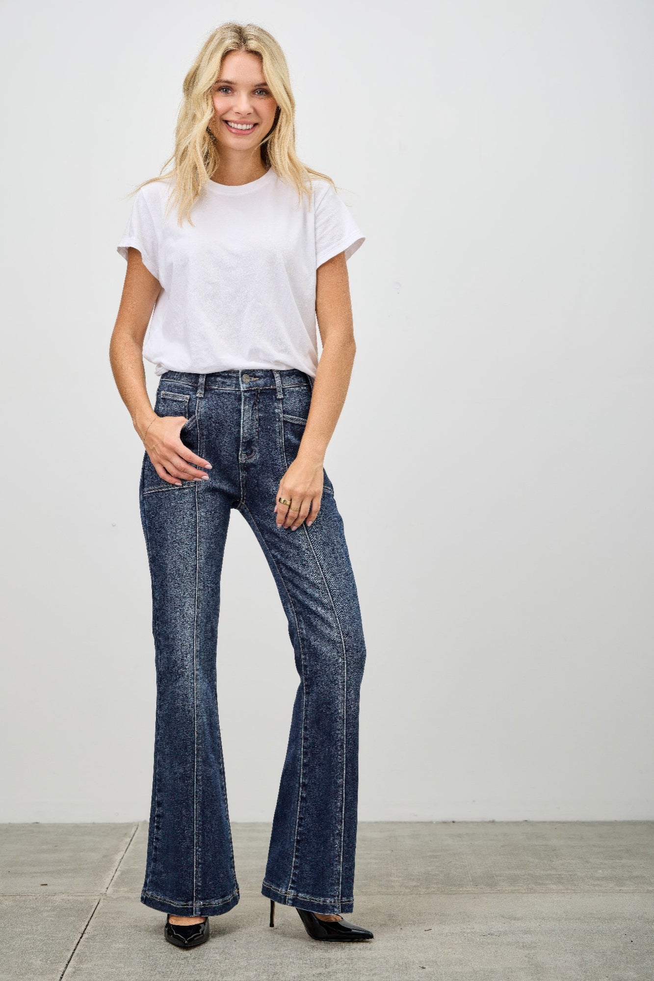 Toshe Women's Fashions high rise boot cut jeans with seam detail, denim fabric, and classic fit, shown on a model.