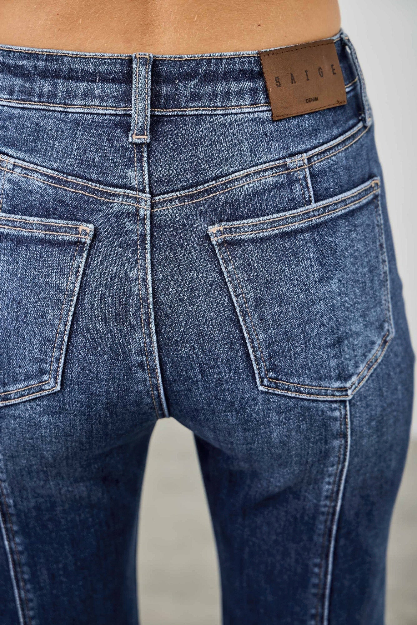 High rise boot cut jeans with seam detail from Toshe Women's Fashions, showing front view with fitted waist and flared legs.