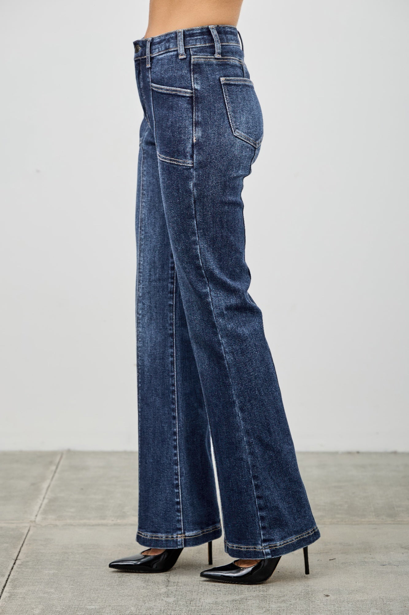 Toshe Women's Fashions high rise boot cut jeans with seam detail, showcasing fit and stylish design on a model.