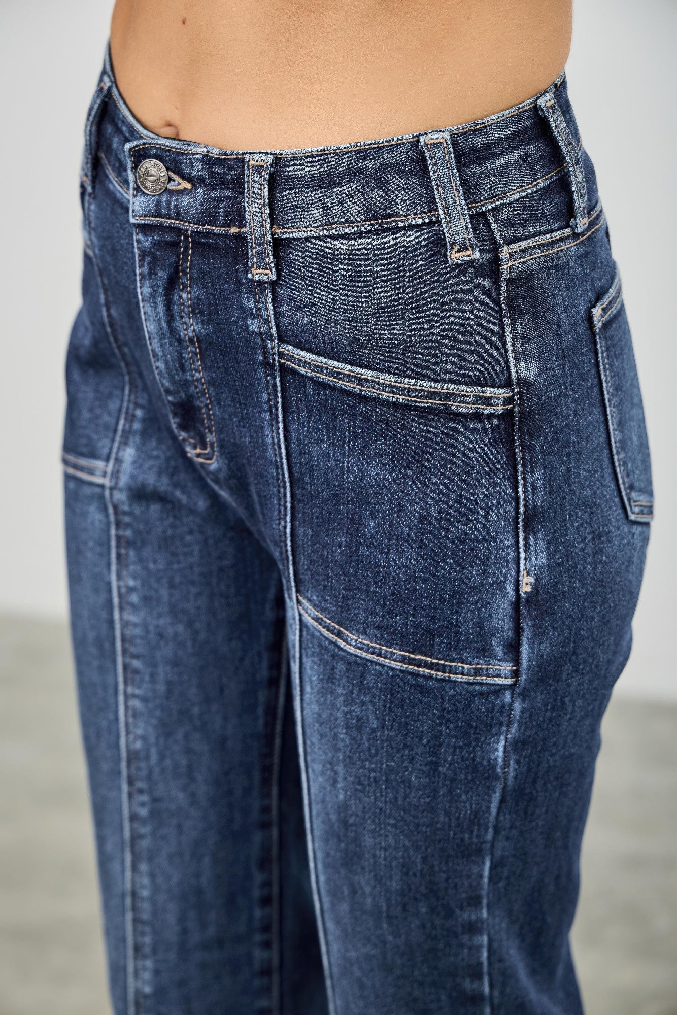 Toshe women's high rise boot cut jeans with seam detail, showcasing the fit and stylish design of the denim pants.