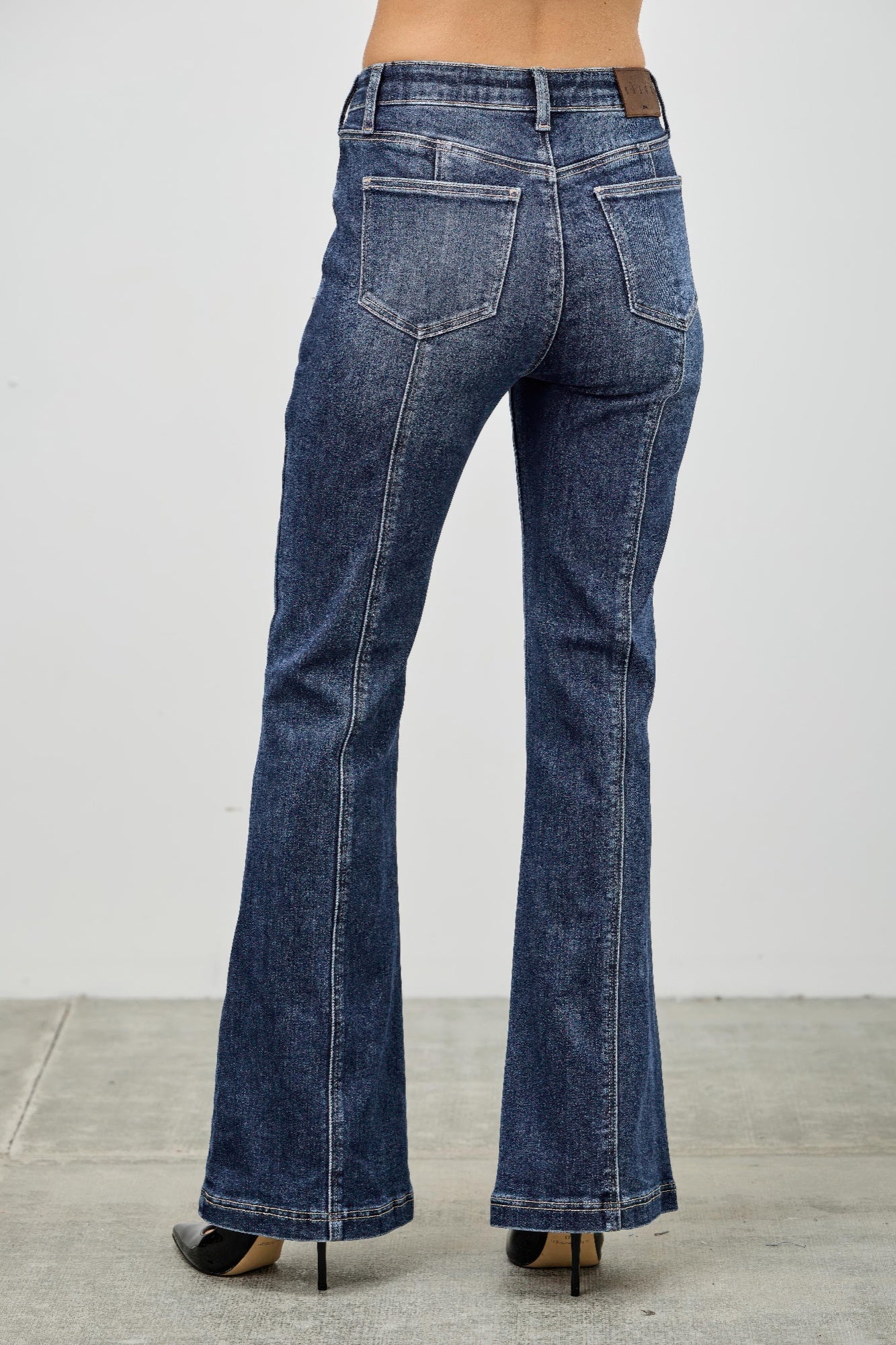 High rise boot cut jeans with seam detail from Toshe Women's Fashions, featuring a classic denim look and fitted waist.